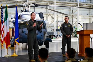 wing commander standing on stage speaking to audience