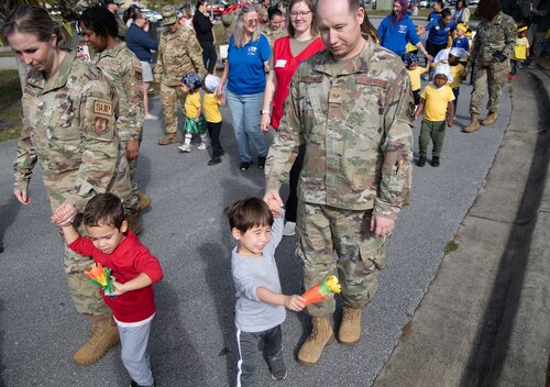 Toddlers and family members walk by during a Child Development Center parade.