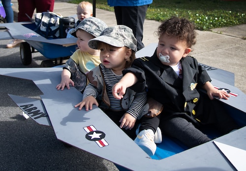 A float of babies rolls by during a Child Development Center parade.