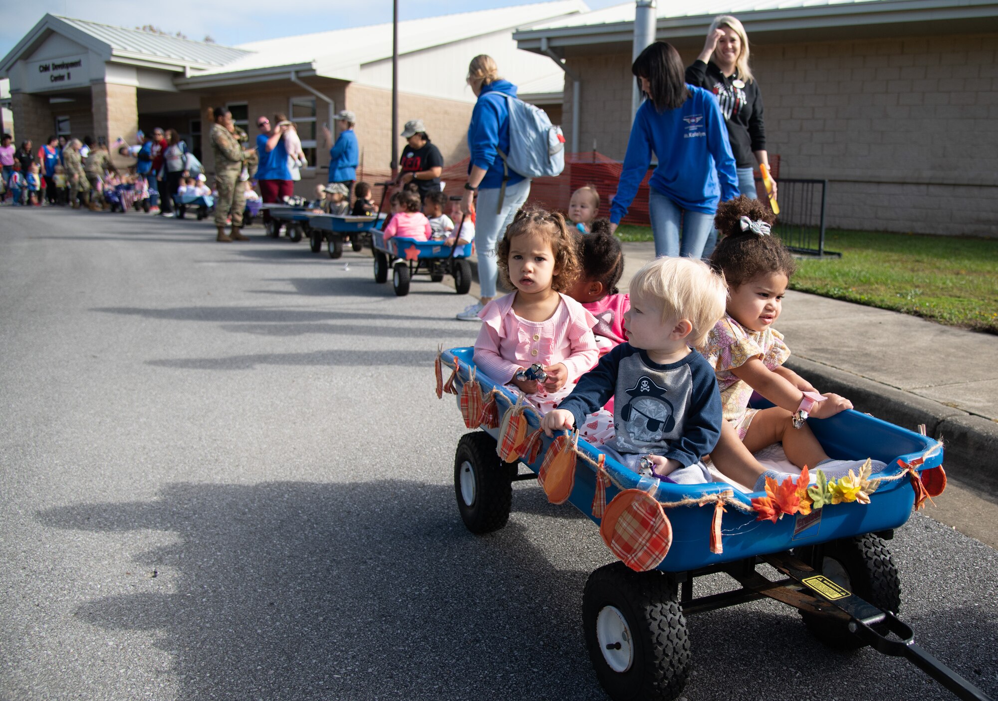 Floats of babies and toddlers stroll around the block during a Child Development Center parade.
