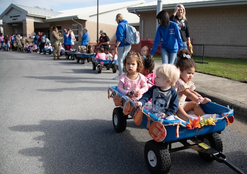 Floats of babies and toddlers stroll around the block during a Child Development Center parade.