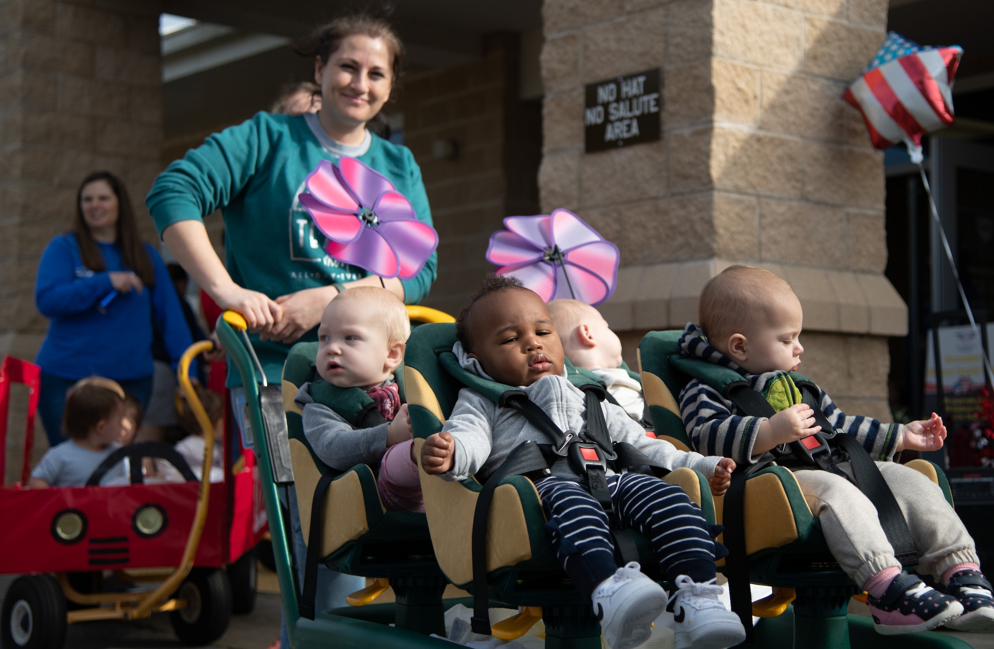 A float of babies rolls by during a Child Development Center parade.