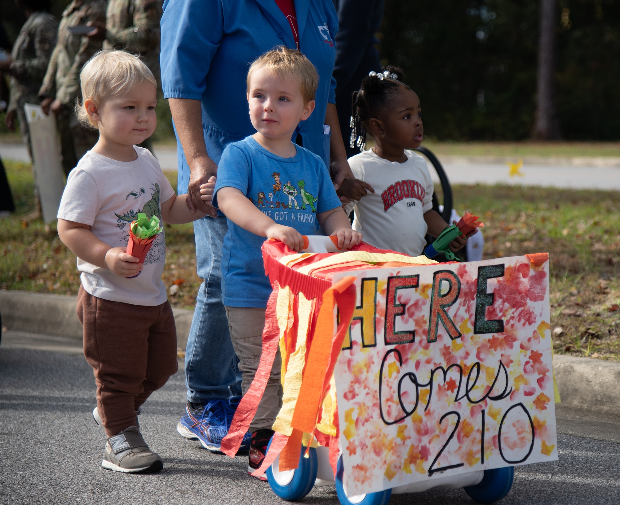 A group of toddlers walk by during a Child Development Center parade.