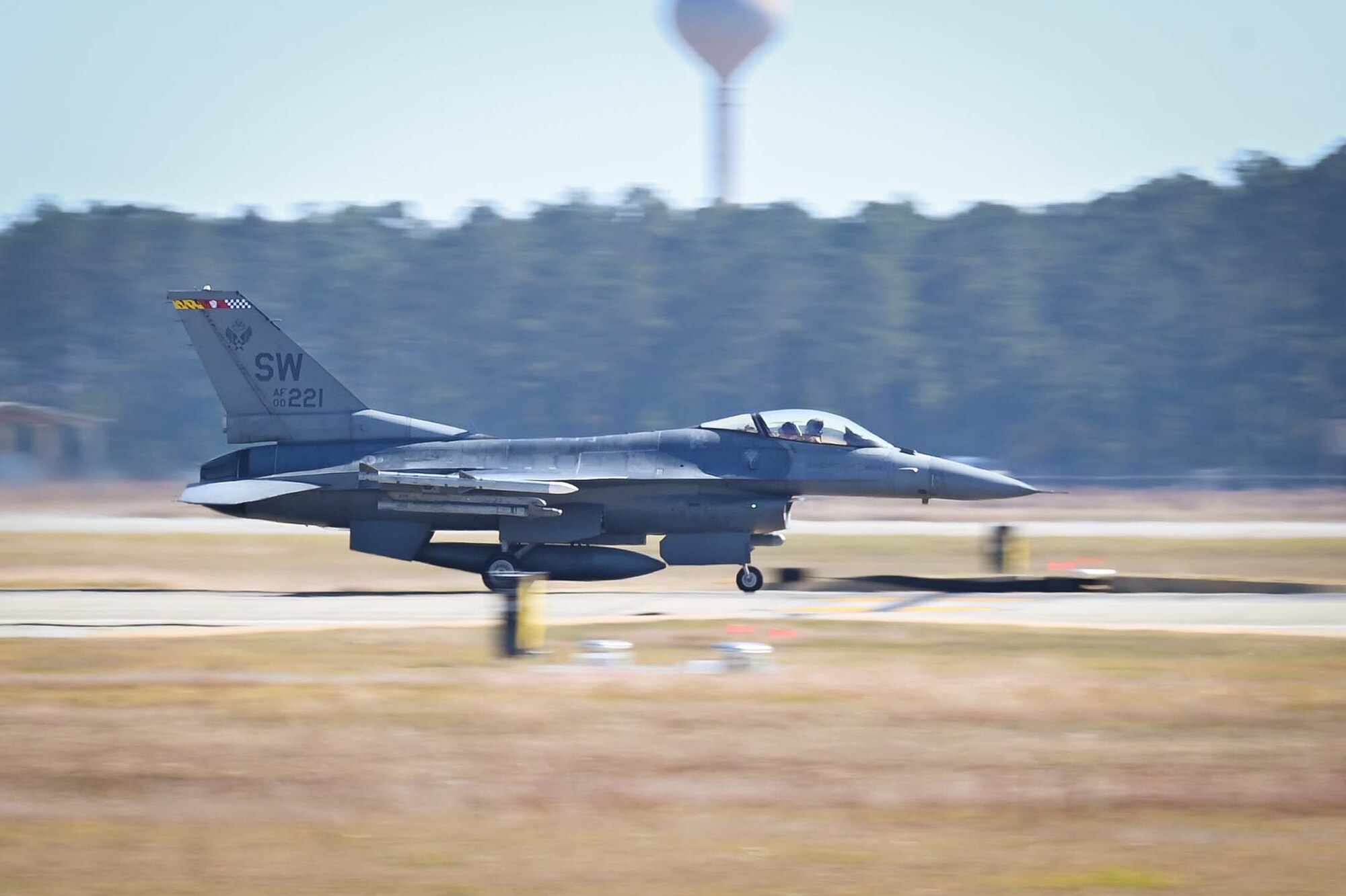 An F-16 takes off from the flightline.