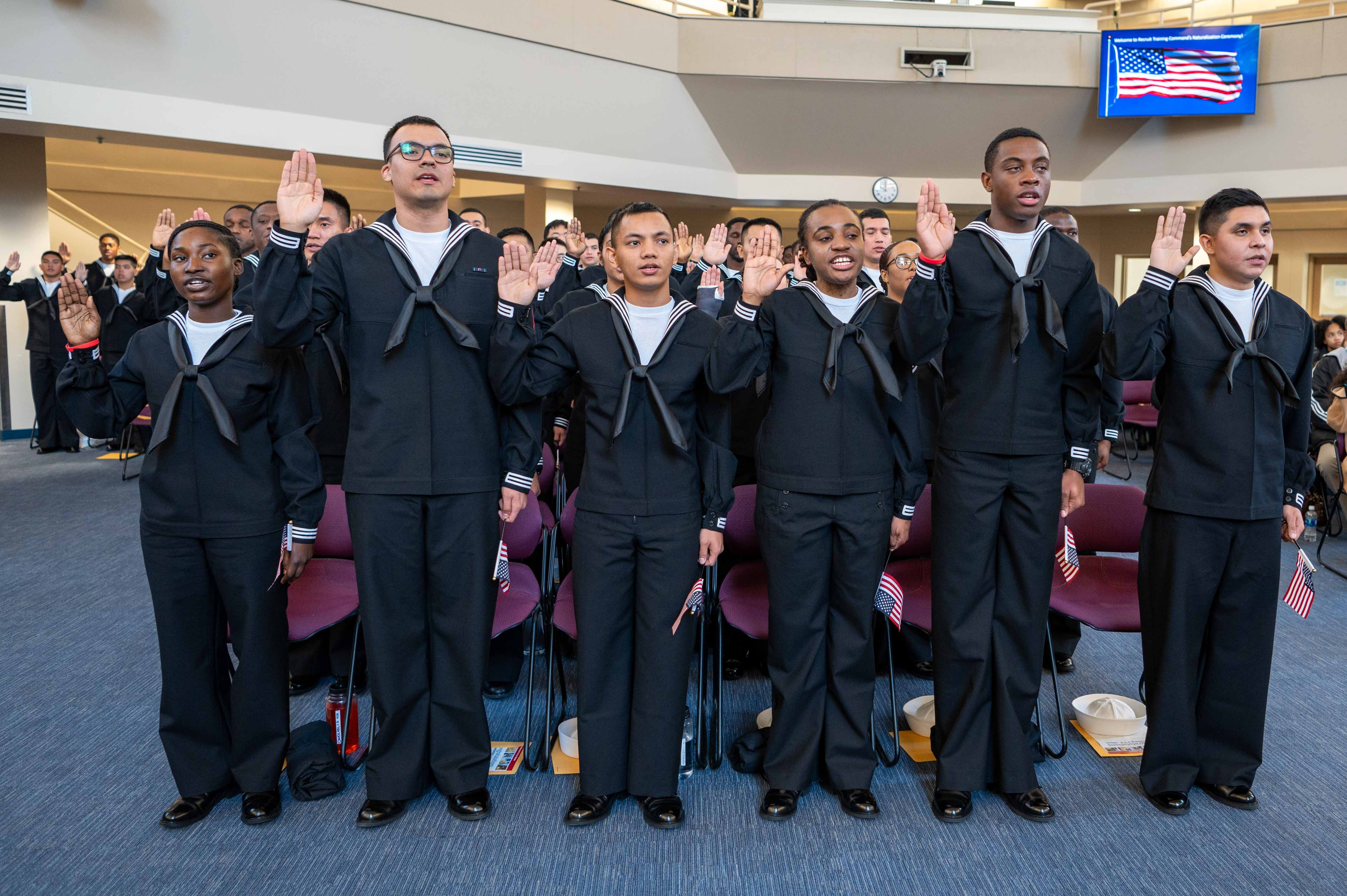 Sailors take the naturalization oath during a naturalization ceremony at Recruit Training Command.