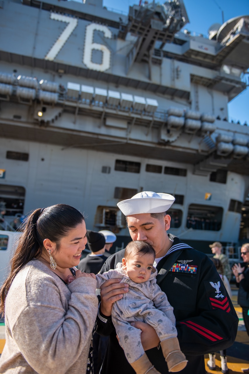 YOKOSUKA, Japan (Nov. 19, 2023) Aviation Support Equipment Technician 1st Class Ricardo Mendoza, from McGregor, Texas, greets family members on the pier as the U.S. Navy’s only forward-deployed aircraft carrier, USS Ronald Reagan (CVN 76), returns to Commander, Fleet Activities Yokosuka, Japan, following a six-month deployment in the Indo-Pacific region, Nov. 19. During Ronald Reagan’s deployment, the ship conducted multinational exercises with the Japan Maritime Self-Defense Force (JMSDF), Royal Australian Navy, Indonesian Navy, and Republic of Korea Navy, a multi-large deck event with USS Carl Vinson (CVN 70), Carrier Strike Group 1, and JMSDF first-in-class helicopter destroyer JS Hyuga (DDH 181), and visited Vietnam, Republic of Korea, and the Philippines. Ronald Reagan, the flagship of Carrier Strike Group 5, provides a combat-ready force that protects and defends the United States, and supports alliances, partnerships and collective maritime interests in the Indo-Pacific region. (U.S. Navy photo by Mass Communication Specialist 2nd Class Caroline H. Lui)