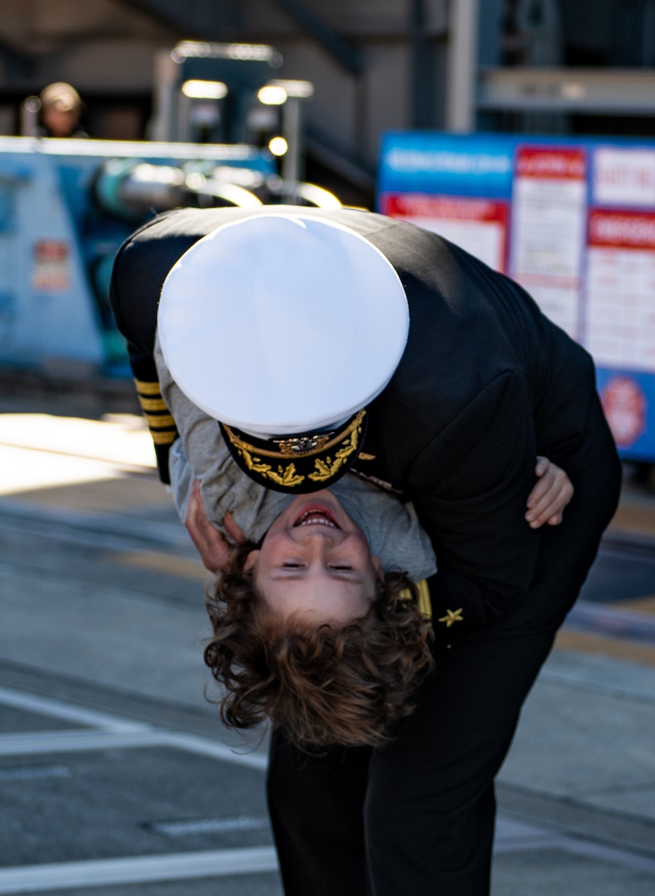 YOKOSUKA, Japan (Nov. 19, 2023) Capt. Justin Issler, executive officer of the U.S. Navy’s only forward-deployed aircraft carrier, USS Ronald Reagan (CVN 76), greets a family member on the pier as the ship returns to Commander, Fleet Activities Yokosuka, Japan, following a six-month deployment in the Indo-Pacific region, Nov. 19. During Ronald Reagan’s deployment, the ship conducted multinational exercises with the Japan Maritime Self-Defense Force (JMSDF), Royal Australian Navy, Indonesian Navy, and Republic of Korea Navy, a multi-large deck event with USS Carl Vinson (CVN 70), Carrier Strike Group 1, and JMSDF first-in-class helicopter destroyer JS Hyuga (DDH 181), and visited Vietnam, Republic of Korea, and the Philippines. Ronald Reagan, the flagship of Carrier Strike Group 5, provides a combat-ready force that protects and defends the United States, and supports alliances, partnerships and collective maritime interests in the Indo-Pacific region. (U.S. Navy photo by Mass Communication Specialist 2nd Class Caroline H. Lui)