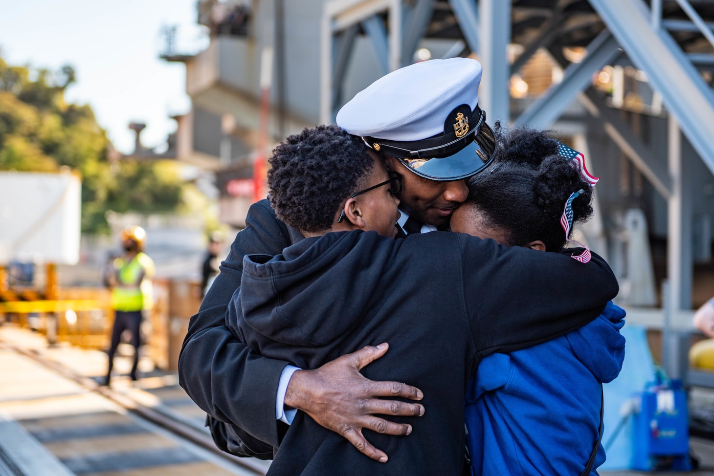 YOKOSUKA, Japan (Nov. 19, 2023) Chief Aviation Boatswain’s Mate (Aircraft Handling) Terry Keyes, from Bay Springs, Mississippi, greets family members on the pier as the U.S. Navy’s only forward-deployed aircraft carrier, USS Ronald Reagan (CVN 76), returns to Commander, Fleet Activities Yokosuka, Japan, following a six-month deployment in the Indo-Pacific region, Nov. 19. During Ronald Reagan’s deployment, the ship conducted multinational exercises with the Japan Maritime Self-Defense Force (JMSDF), Royal Australian Navy, Indonesian Navy, and Republic of Korea Navy, a multi-large deck event with USS Carl Vinson (CVN 70), Carrier Strike Group 1, and JMSDF first-in-class helicopter destroyer JS Hyuga (DDH 181), and visited Vietnam, Republic of Korea, and the Philippines. Ronald Reagan, the flagship of Carrier Strike Group 5, provides a combat-ready force that protects and defends the United States, and supports alliances, partnerships and collective maritime interests in the Indo-Pacific region. (U.S. Navy photo by Mass Communication Specialist 2nd Class Caroline H. Lui)