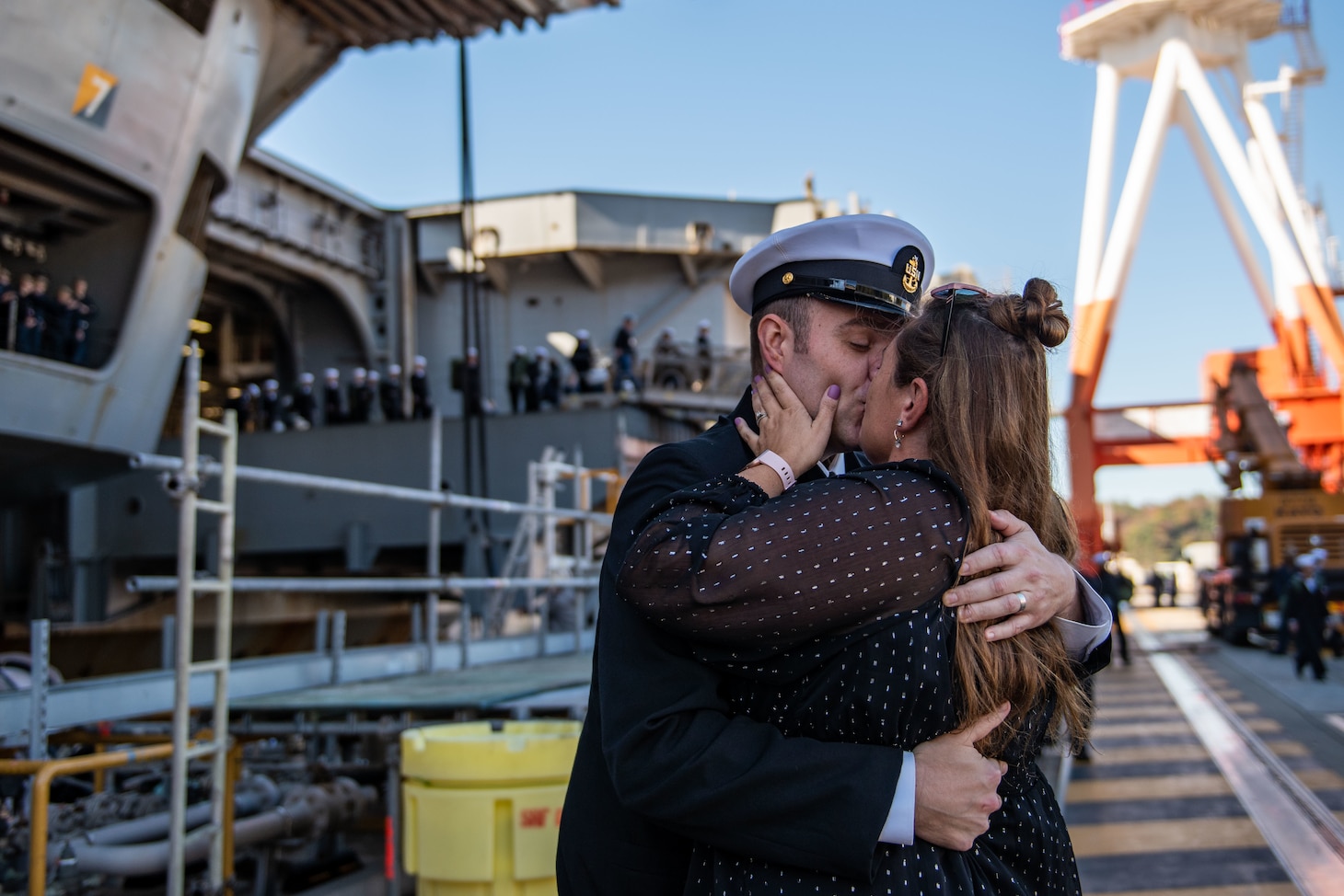 YOKOSUKA, Japan (Nov. 19, 2023) Senior Chief Mass Communication Specialist Matthew White, from Kettering, Ohio, greets his wife on the pier as the U.S. Navy’s only forward-deployed aircraft carrier, USS Ronald Reagan (CVN 76), returns to Commander, Fleet Activities Yokosuka, Japan, following a six-month deployment in the Indo-Pacific region, Nov. 19. During Ronald Reagan’s deployment, the ship conducted multinational exercises with the Japan Maritime Self-Defense Force (JMSDF), Royal Australian Navy, Indonesian Navy, and Republic of Korea Navy, a multi-large deck event with USS Carl Vinson (CVN 70), Carrier Strike Group 1, and JMSDF first-in-class helicopter destroyer JS Hyuga (DDH 181), and visited Vietnam, Republic of Korea, and the Philippines. Ronald Reagan, the flagship of Carrier Strike Group 5, provides a combat-ready force that protects and defends the United States, and supports alliances, partnerships and collective maritime interests in the Indo-Pacific region. (U.S. Navy photo by Mass Communication Specialist 2nd Class Caroline H. Lui)