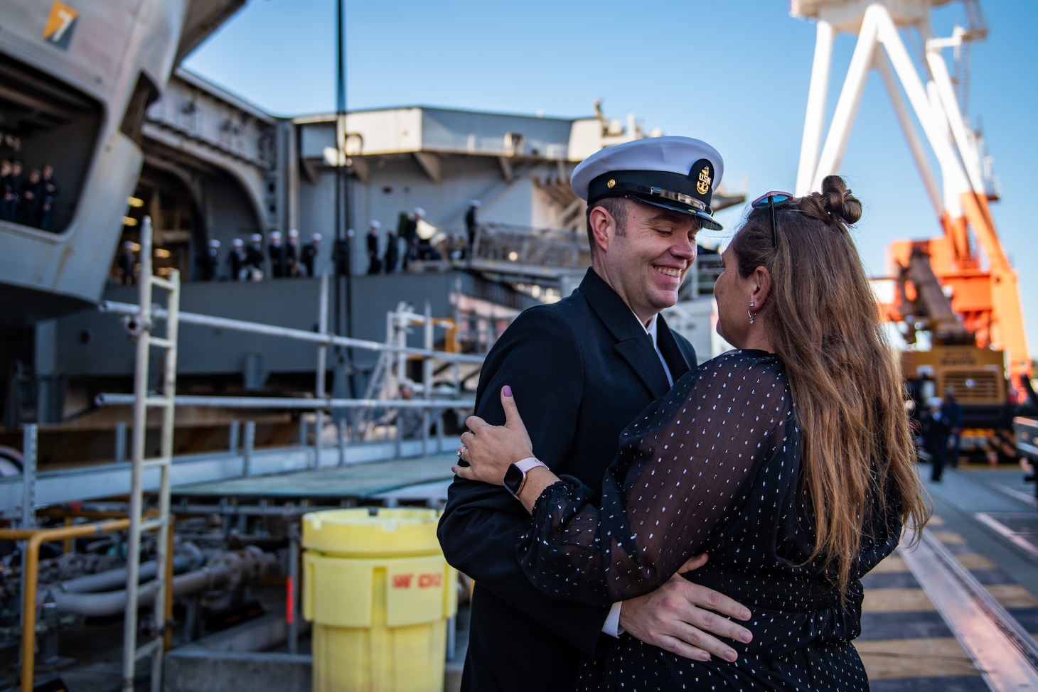 YOKOSUKA, Japan (Nov. 19, 2023) Senior Chief Mass Communication Specialist Matthew White, from Kettering, Ohio, greets his wife on the pier as the U.S. Navy’s only forward-deployed aircraft carrier, USS Ronald Reagan (CVN 76), returns to Commander, Fleet Activities Yokosuka, Japan, following a six-month deployment in the Indo-Pacific region, Nov. 19. During Ronald Reagan’s deployment, the ship conducted multinational exercises with the Japan Maritime Self-Defense Force (JMSDF), Royal Australian Navy, Indonesian Navy, and Republic of Korea Navy, a multi-large deck event with USS Carl Vinson (CVN 70), Carrier Strike Group 1, and JMSDF first-in-class helicopter destroyer JS Hyuga (DDH 181), and visited Vietnam, Republic of Korea, and the Philippines. Ronald Reagan, the flagship of Carrier Strike Group 5, provides a combat-ready force that protects and defends the United States, and supports alliances, partnerships and collective maritime interests in the Indo-Pacific region. (U.S. Navy photo by Mass Communication Specialist 2nd Class Caroline H. Lui)