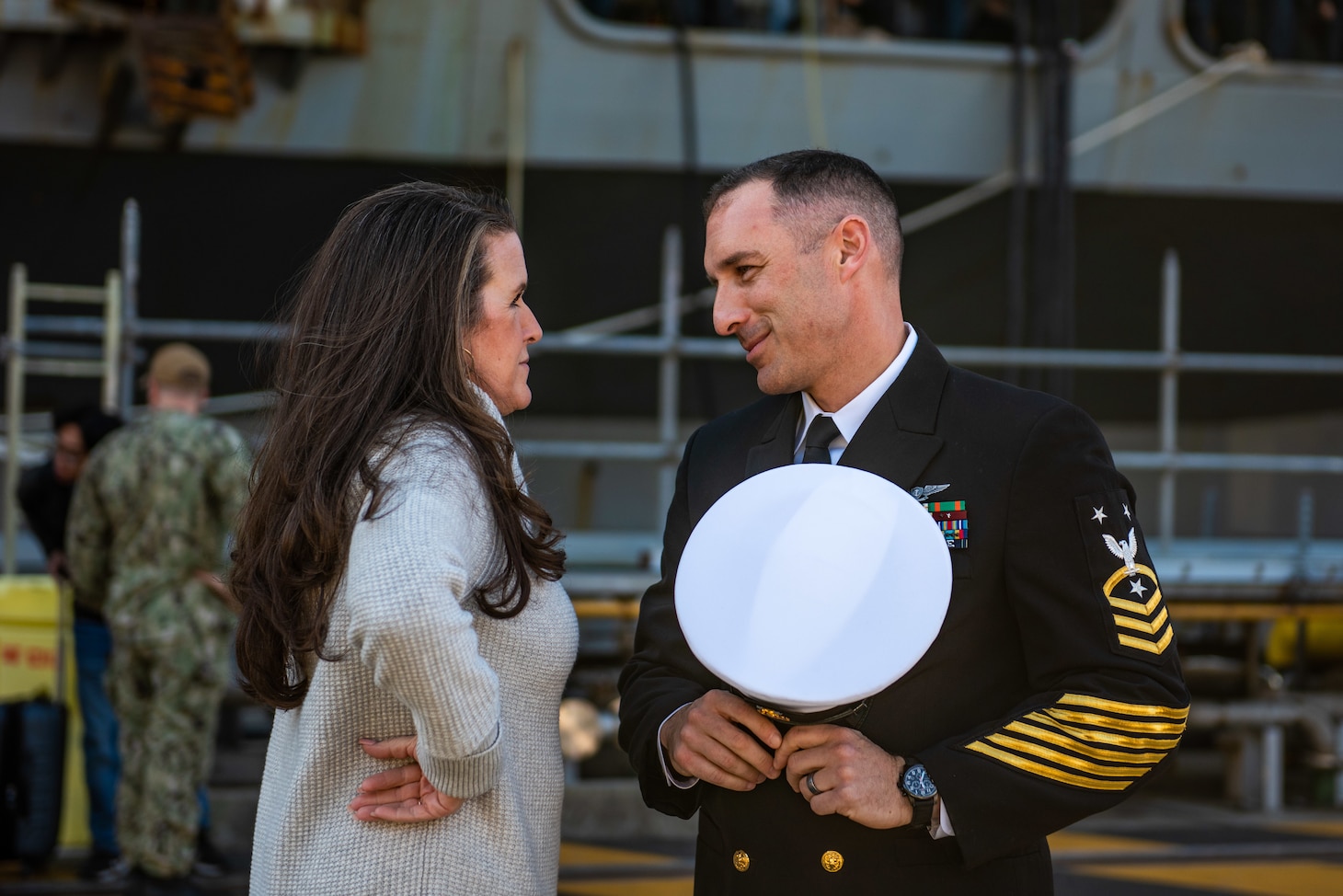 YOKOSUKA, Japan (Nov. 19, 2023) Command Master Chief Jeremy Douglas, command master chief of the U.S. Navy’s only forward-deployed aircraft carrier, USS Ronald Reagan (CVN 76), speaks with his wife on the pier as the ship returns to Commander, Fleet Activities Yokosuka, Japan, following a six-month deployment in the Indo-Pacific region, Nov. 19. During Ronald Reagan’s deployment, the ship conducted multinational exercises with the Japan Maritime Self-Defense Force (JMSDF), Royal Australian Navy, Indonesian Navy, and Republic of Korea Navy, a multi-large deck event with USS Carl Vinson (CVN 70), Carrier Strike Group 1, and JMSDF first-in-class helicopter destroyer JS Hyuga (DDH 181), and visited Vietnam, Republic of Korea, and the Philippines. Ronald Reagan, the flagship of Carrier Strike Group 5, provides a combat-ready force that protects and defends the United States, and supports alliances, partnerships and collective maritime interests in the Indo-Pacific region. (U.S. Navy photo by Mass Communication Specialist 2nd Class Caroline H. Lui)