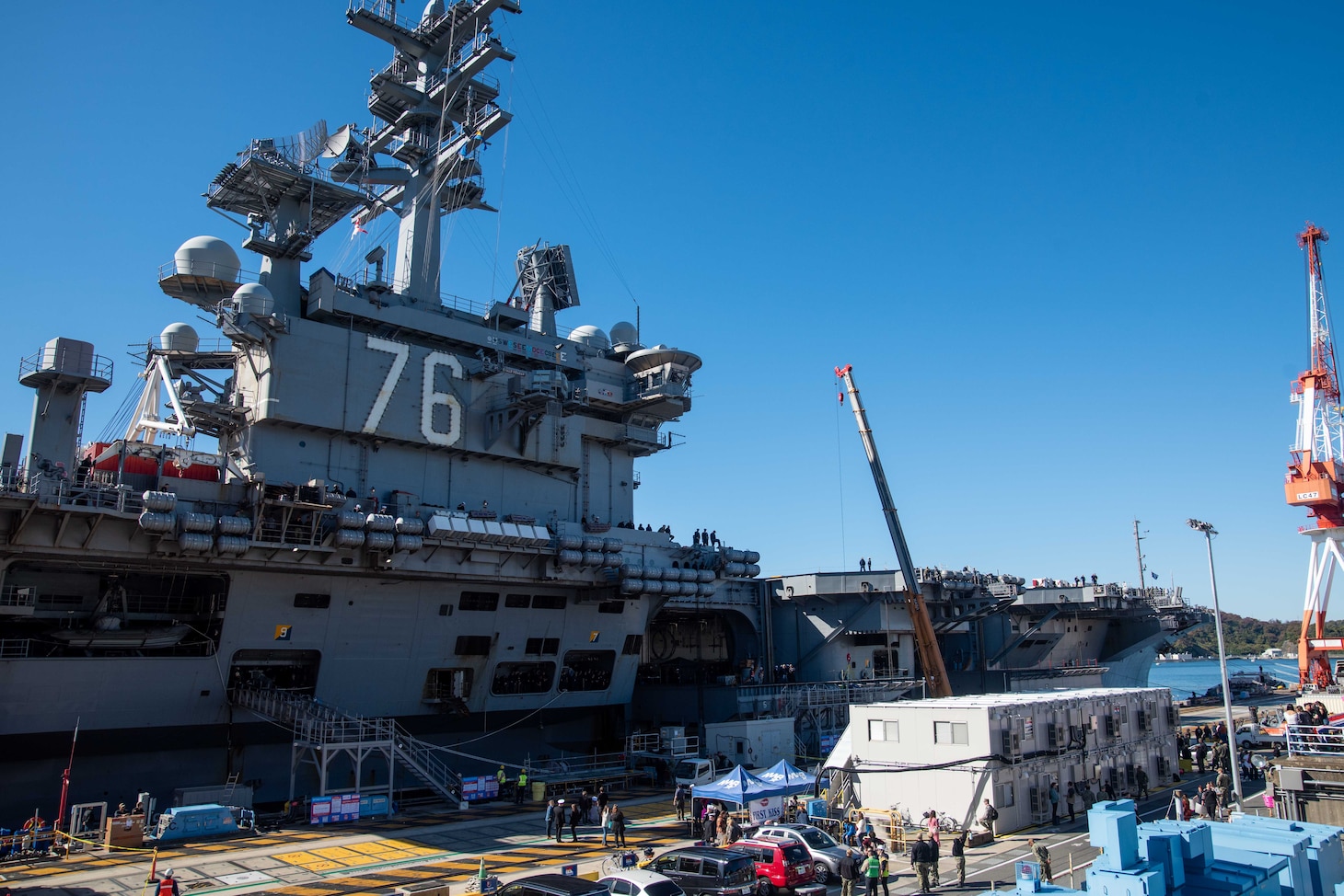 YOKOSUKA, Japan (Nov. 19, 2023) The U.S. Navy’s only forward-deployed aircraft carrier, USS Ronald Reagan (CVN 76), at the pier after its return to Commander, Fleet Activities Yokosuka, Japan, following a six-month deployment in the Indo-Pacific region, Nov. 19. During Ronald Reagan’s deployment, the ship conducted multinational exercises with the Japan Maritime Self-Defense Force (JMSDF), Royal Australian Navy, Indonesian Navy, and Republic of Korea Navy, a multi-large deck event with USS Carl Vinson (CVN 70), Carrier Strike Group 1, and JMSDF first-in-class helicopter destroyer JS Hyuga (DDH 181), and visited Vietnam, Republic of Korea, and the Philippines. Ronald Reagan, the flagship of Carrier Strike Group 5, provides a combat-ready force that protects and defends the United States, and supports alliances, partnerships and collective maritime interests in the Indo-Pacific region. (U.S. Navy photo by Mass Communication Specialist 3rd Class Jordan Brown)