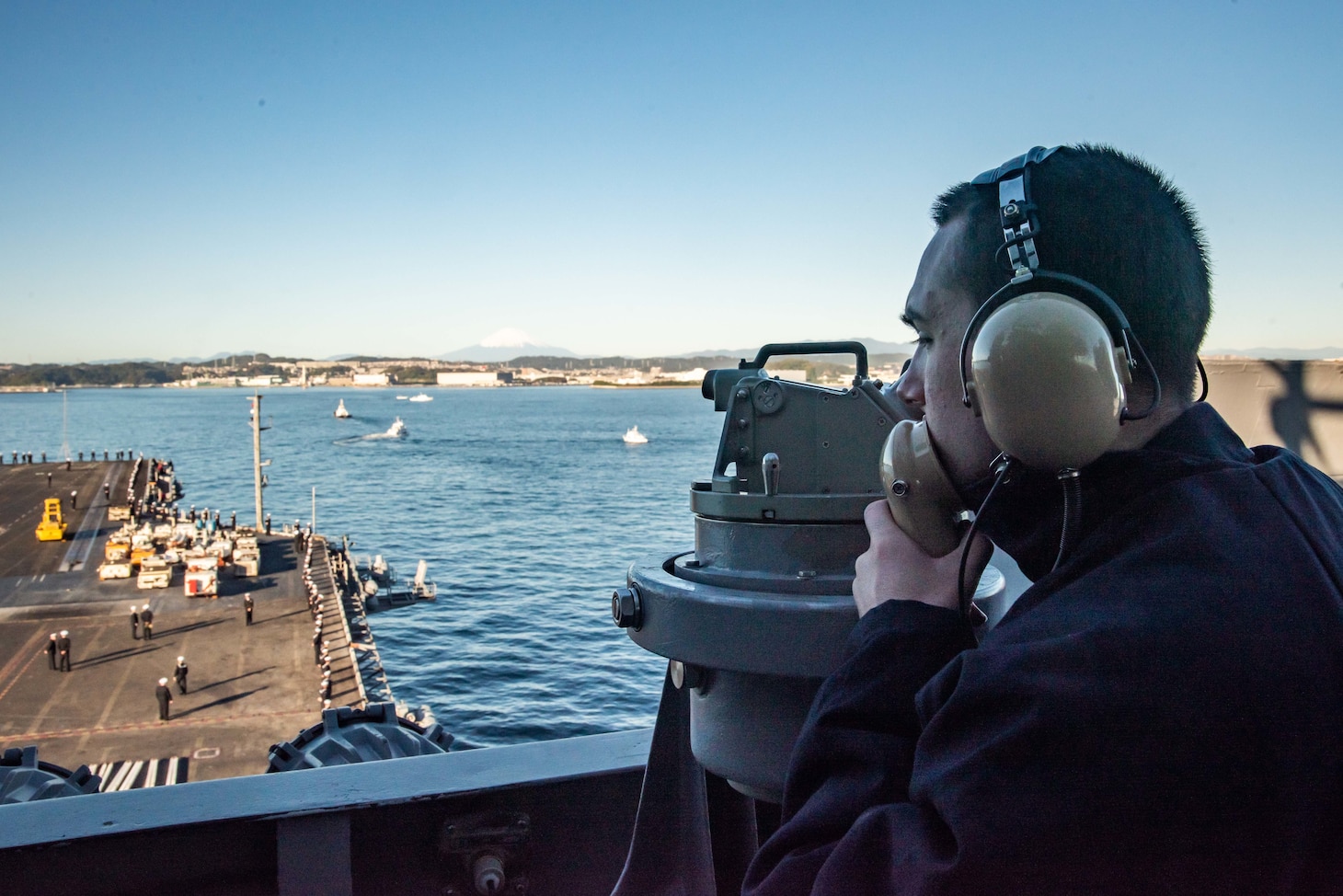 YOKOSUKA, Japan (Nov. 19, 2023) Quartermaster 3rd Class Myron Baker, from Springtown, Texas, stands watch on vulture’s row as the U.S. Navy’s only forward-deployed aircraft carrier, USS Ronald Reagan (CVN 76), returns to Commander, Fleet Activities Yokosuka, Japan, following a six-month deployment in the Indo-Pacific region, Nov. 19. During Ronald Reagan’s deployment, the ship conducted multinational exercises with the Japan Maritime Self-Defense Force (JMSDF), Royal Australian Navy, Indonesian Navy, and Republic of Korea Navy, a multi-large deck event with USS Carl Vinson (CVN 70), Carrier Strike Group 1, and JMSDF first-in-class helicopter destroyer, JS Hyuga (DDH 181), and visited Vietnam, Republic of Korea, and the Philippines. Ronald Reagan, the flagship of Carrier Strike Group 5, provides a combat-ready force that protects and defends the United States, and supports alliances, partnerships and collective maritime interests in the Indo-Pacific region. (U.S. Navy photo by Mass Communication Specialist 3rd Class Jordan Brown)