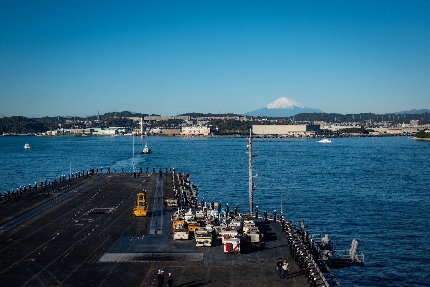 YOKOSUKA, Japan (Nov. 19, 2023) Sailors man the rails on the flight deck as the U.S. Navy’s only forward-deployed aircraft carrier, USS Ronald Reagan (CVN 76), returns to Commander, Fleet Activities Yokosuka, Japan, following a six-month deployment in the Indo-Pacific region, Nov. 19. During Ronald Reagan’s deployment, the ship conducted multinational exercises with the Japan Maritime Self-Defense Force (JMSDF), Royal Australian Navy, Indonesian Navy, and Republic of Korea Navy, a multi-large deck event with USS Carl Vinson (CVN 70), Carrier Strike Group 1, and JMSDF first-in-class helicopter destroyer JS Hyuga (DDH 181), and visited Vietnam, Republic of Korea, and the Philippines. Ronald Reagan, the flagship of Carrier Strike Group 5, provides a combat-ready force that protects and defends the United States, and supports alliances, partnerships and collective maritime interests in the Indo-Pacific region. (U.S. Navy photo by Mass Communication Specialist 3rd Class Jordan Brown)