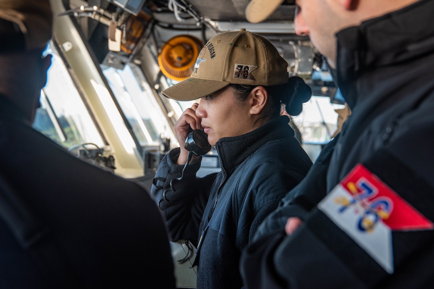 YOKOSUKA, Japan (Nov. 19, 2023) Ensign Melody Medina, from New York, establishes communication on the bridge as the U.S. Navy’s only forward-deployed aircraft carrier, USS Ronald Reagan (CVN 76), returns to Commander, Fleet Activities Yokosuka, Japan, following a six-month deployment in the Indo-Pacific region, Nov. 19. During Ronald Reagan’s deployment, the ship conducted multinational exercises with the Japan Maritime Self-Defense Force (JMSDF), Royal Australian Navy, Indonesian Navy, and Republic of Korea Navy, a multi-large deck event with USS Carl Vinson (CVN 70), Carrier Strike Group 1, and JMSDF first-in-class helicopter destroyer, JS Hyuga (DDH 181), and visited Vietnam, Republic of Korea, and the Philippines. Ronald Reagan, the flagship of Carrier Strike Group 5, provides a combat-ready force that protects and defends the United States, and supports alliances, partnerships and collective maritime interests in the Indo-Pacific region. (U.S. Navy photo by Mass Communication Specialist 3rd Class Jordan Brown)