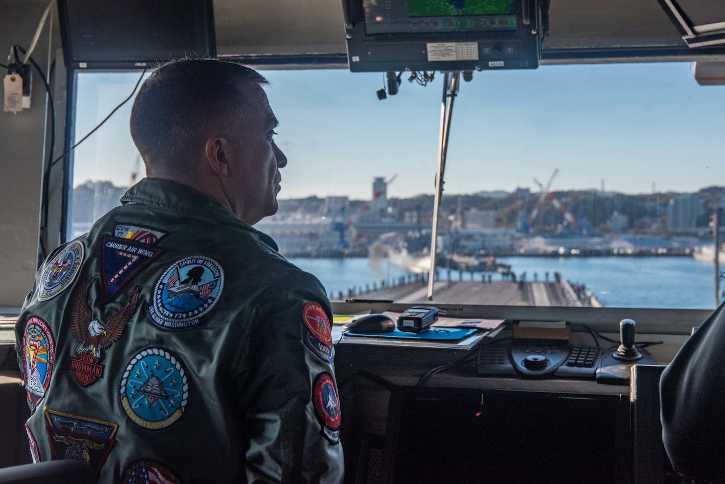 YOKOSUKA, Japan (Nov. 19, 2023) Capt. Daryle Cardone, commanding of the U.S. Navy’s only forward-deployed aircraft carrier, USS Ronald Reagan (CVN 76), observes from the bridge as the ship returns to Commander, Fleet Activities Yokosuka, Japan, following a six-month deployment in the Indo-Pacific region, Nov. 19. During Ronald Reagan’s deployment, the ship conducted multinational exercises with the Japan Maritime Self-Defense Force (JMSDF), Royal Australian Navy, Indonesian Navy, and Republic of Korea Navy, a multi-large deck event with USS Carl Vinson (CVN 70), Carrier Strike Group 1, and JMSDF first-in-class helicopter destroyer, JS Hyuga (DDH 181), and visited Vietnam, Republic of Korea, and the Philippines. Ronald Reagan, the flagship of Carrier Strike Group 5, provides a combat-ready force that protects and defends the United States, and supports alliances, partnerships and collective maritime interests in the Indo-Pacific region. (U.S. Navy photo by Mass Communication Specialist 3rd Class Jordan Brown)