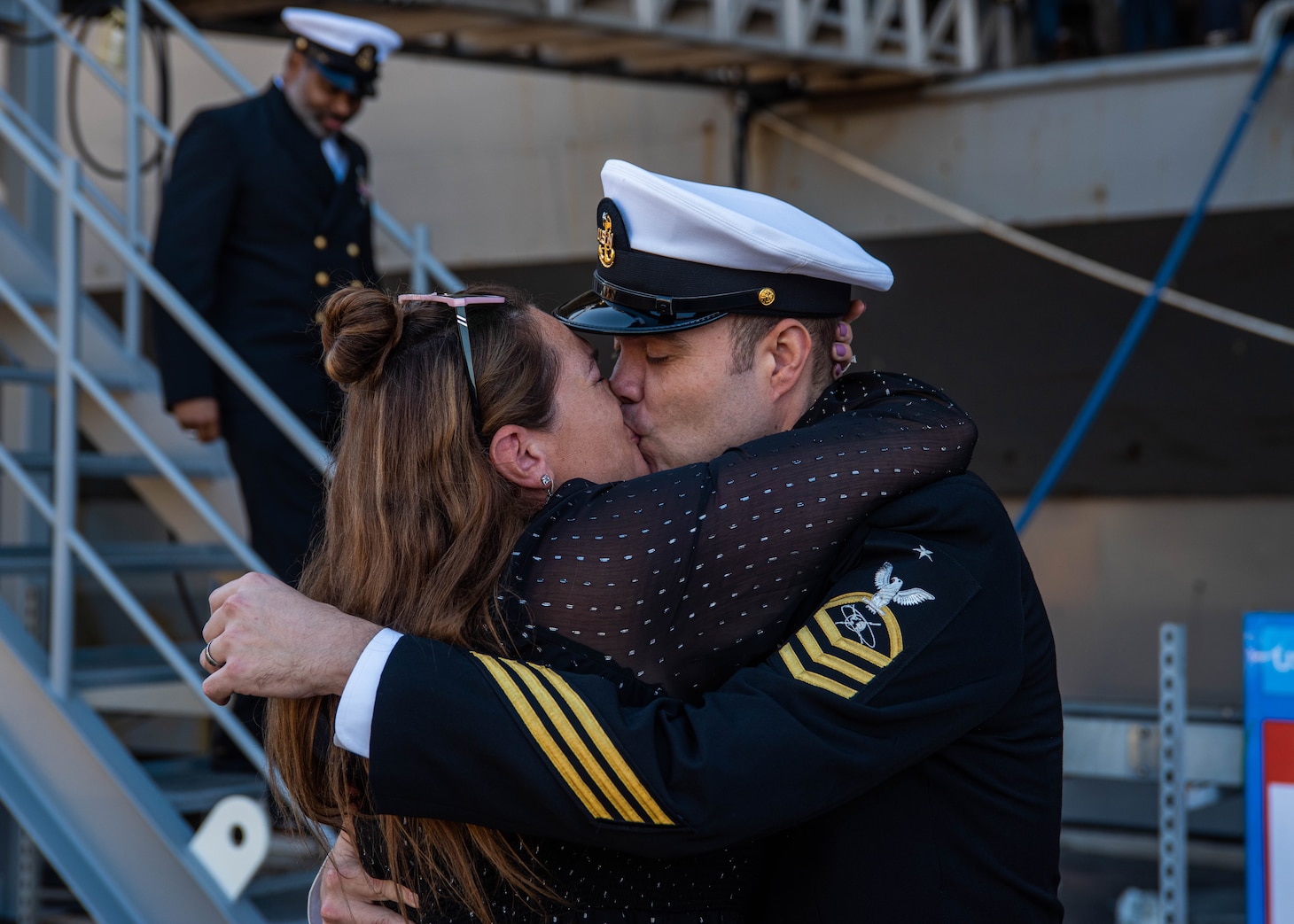 YOKOSUKA, Japan (Nov. 19, 2023) Senior Chief Mass Communication Specialist Matthew White, kisses his wife on the pier after the U.S. Navy’s only forward-deployed aircraft carrier, USS Ronald Reagan (CVN 76), returns to Commander, Fleet Activities Yokosuka, Japan, following a six-month deployment in the Indo-Pacific region, Nov. 19. During Ronald Reagan’s deployment, the ship conducted multinational exercises with the Japan Maritime Self-Defense Force (JMSDF), Royal Australian Navy, Indonesian Navy, and Republic of Korea Navy, a multi-large deck event with USS Carl Vinson (CVN 70), Carrier Strike Group 1, and JMSDF first-in-class helicopter destroyer JS Hyuga (DDH 181), and visited Vietnam, Republic of Korea, and the Philippines. Ronald Reagan, the flagship of Carrier Strike Group 5, provides a combat-ready force that protects and defends the United States, and supports alliances, partnerships and collective maritime interests in the Indo-Pacific region. (U.S. Navy photo by Mass Communication Specialist 3rd Class Jordan Brown)