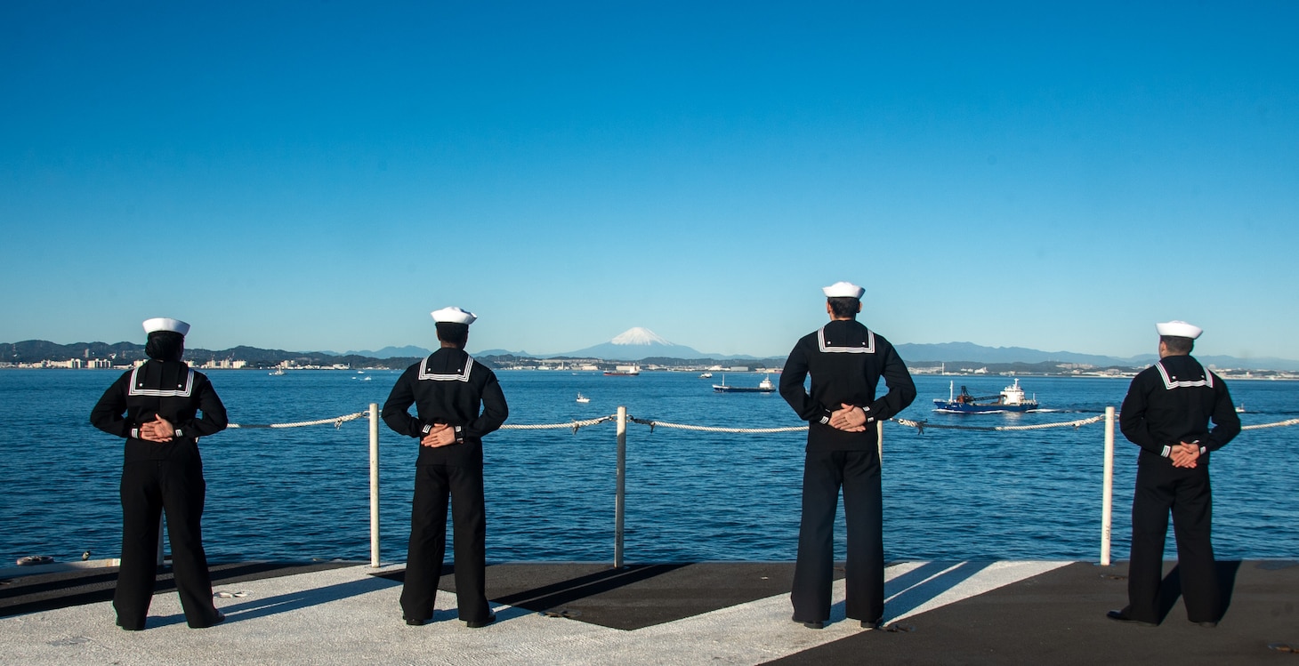 YOKOSUKA, Japan (Nov. 19, 2023) Sailors man the rails on the flight deck as the U.S. Navy’s only forward-deployed aircraft carrier, USS Ronald Reagan (CVN 76), returns to Commander, Fleet Activities Yokosuka, Japan, following a six-month deployment in the Indo-Pacific region, Nov. 19. During Ronald Reagan’s deployment, the ship conducted multinational exercises with the Japan Maritime Self-Defense Force (JMSDF), Royal Australian Navy, Indonesian Navy, and Republic of Korea Navy, a multi-large deck event with USS Carl Vinson (CVN 70), Carrier Strike Group 1, and JMSDF first-in-class helicopter destroyer, JS Hyuga (DDH 181), and visited Vietnam, Republic of Korea, and the Philippines. Ronald Reagan, the flagship of Carrier Strike Group 5, provides a combat-ready force that protects and defends the United States, and supports alliances, partnerships and collective maritime interests in the Indo-Pacific region. (U.S. Navy photo by Mass Communication Specialist 3rd Class Heather McGee)