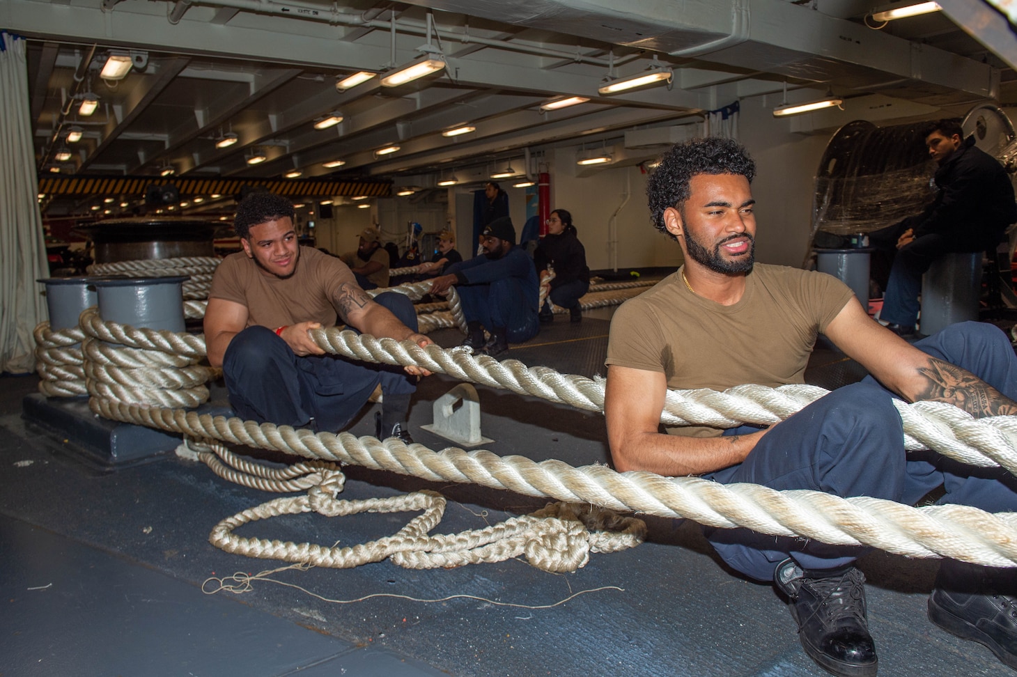 YOKOSUKA, Japan (Nov. 19, 2023) Sailors hold tension on a mooring line in the forecastle as the U.S. Navy’s only forward-deployed aircraft carrier, USS Ronald Reagan (CVN 76), returns to Commander, Fleet Activities Yokosuka, Japan, following a six-month deployment in the Indo-Pacific region, Nov. 19. During Ronald Reagan’s deployment, the ship conducted multinational exercises with the Japan Maritime Self-Defense Force (JMSDF), Royal Australian Navy, Indonesian Navy, and Republic of Korea Navy, a multi-large deck event with USS Carl Vinson (CVN 70), Carrier Strike Group 1, and JMSDF first-in-class helicopter destroyer JS Hyuga (DDH 181), and visited Vietnam, Republic of Korea, and the Philippines. Ronald Reagan, the flagship of Carrier Strike Group 5, provides a combat-ready force that protects and defends the United States, and supports alliances, partnerships and collective maritime interests in the Indo-Pacific region. (U.S. Navy photo by Mass Communication Specialist Seaman Kyree Rogers)