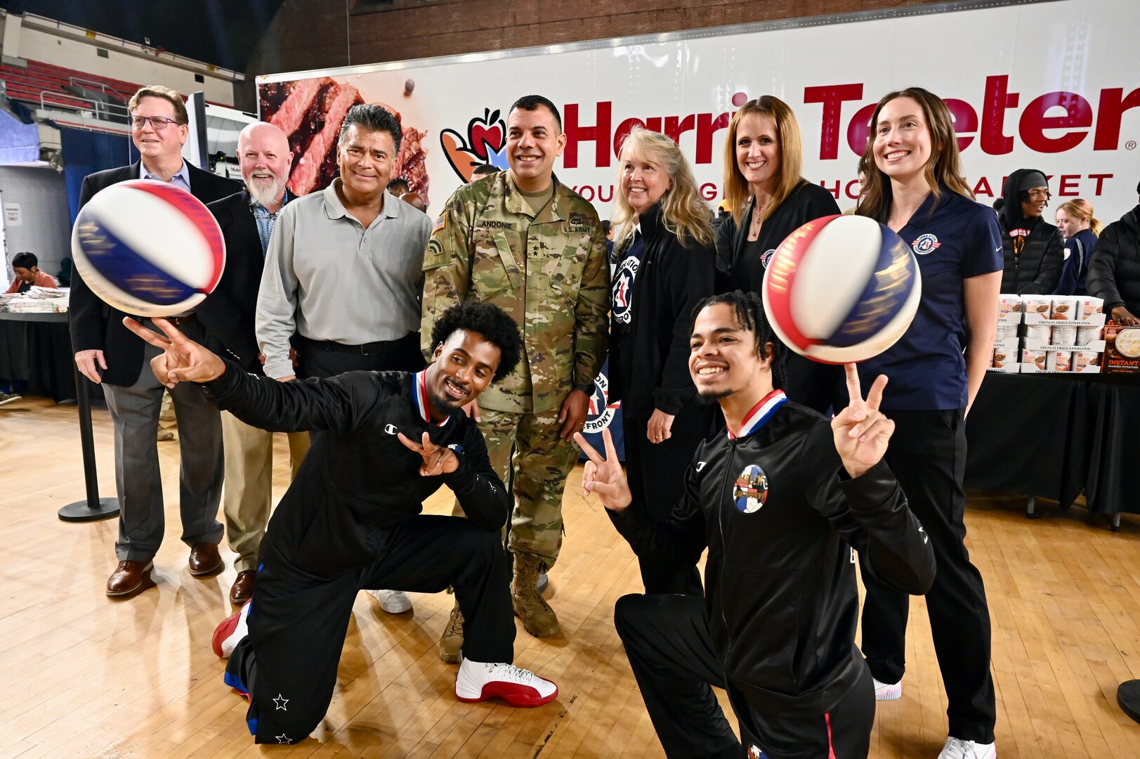 Harlem Globetrotters "Too Tall” Winston and "Wham” Middleton thank District of Columbia National Guard members, while also participating in a holiday meal distribution during a Operation Homefront ‘Holiday Meals for Military’ event at the D.C. Armory on Nov. 17, 2023. Operation Homefront provides programs designed to build strong, stable, and secure military families. (U.S. Air National Guard photo by MSgt Arthur M. Wright)