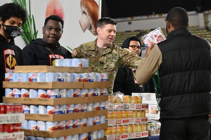 Harlem Globetrotters "Too Tall” Winston and "Wham” Middleton thank District of Columbia National Guard members, while also participating in a holiday meal distribution during a Operation Homefront ‘Holiday Meals for Military’ event at the D.C. Armory on Nov. 17, 2023. Operation Homefront provides programs designed to build strong, stable, and secure military families. (U.S. Air National Guard photo by MSgt Arthur M. Wright)