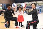 Harlem Globetrotters "Too Tall” Winston and "Wham” Middleton thank District of Columbia National Guard members, while also participating in a holiday meal distribution during a Operation Homefront ‘Holiday Meals for Military’ event at the D.C. Armory on Nov. 17, 2023. Operation Homefront provides programs designed to build strong, stable, and secure military families. (U.S. Air National Guard photo by MSgt Arthur M. Wright)