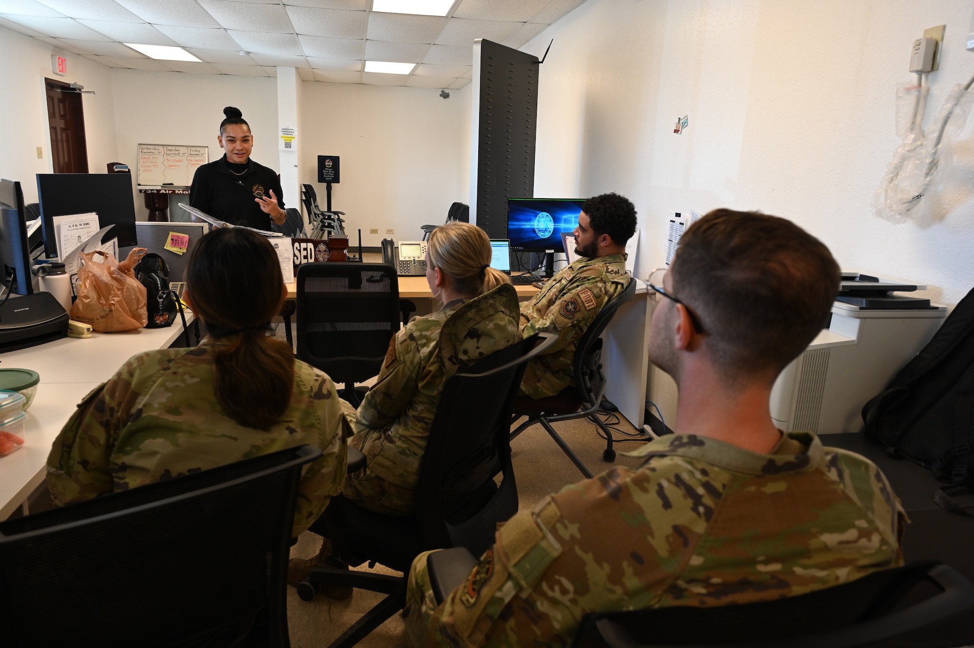 A government worker teaches Airmen about travel eligibility.