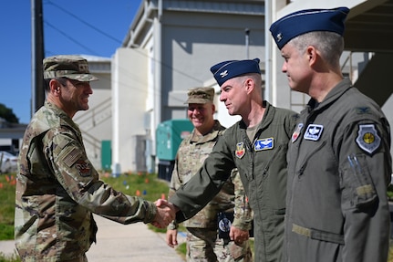 Lt. Gen. Kevin Kennedy, Commander, 16th Air Force (Air Forces Cyber), shakes hands with U.S. Air Force Col. John A. Christianson, 350th Spectrum Warfare Wing deputy commander, during a visit at Eglin Air Force Base, Fla., Nov. 3, 2023. The 350th SWW serves as the Air Force’s first Electromagnetic Spectrum (EMS) focused wing on enhancing air component commanders’ ability to synchronize, integrate and execute EMS capabilities across all domains and platforms. (U.S. Air Force photo by Staff Sgt. Ericka A. Woolever)