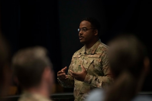 A military man speaks in front of an audience.