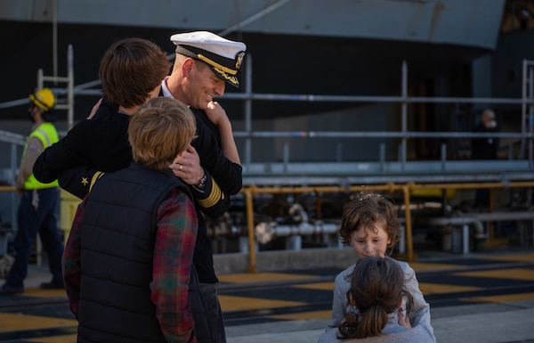 YOKOSUKA, Japan (Nov. 19, 2023) Capt. Justin Issler, executive officer of the U.S. Navy’s only forward-deployed aircraft carrier, USS Ronald Reagan (CVN 76), greets family members on the pier as the ship returns to Commander, Fleet Activities Yokosuka, Japan, following a six-month deployment in the Indo-Pacific region, Nov. 19. During Ronald Reagan’s deployment, the ship conducted multinational exercises with the Japan Maritime Self-Defense Force (JMSDF), Royal Australian Navy, Indonesian Navy, and Republic of Korea Navy, a multi-large deck event with USS Carl Vinson (CVN 70), Carrier Strike Group 1, and JMSDF first-in-class helicopter destroyer JS Hyuga (DDH 181), and visited Vietnam, Republic of Korea, and the Philippines. Ronald Reagan, the flagship of Carrier Strike Group 5, provides a combat-ready force that protects and defends the United States, and supports alliances, partnerships and collective maritime interests in the Indo-Pacific region. (U.S. Navy photo by Mass Communication Specialist 2nd Class Caroline H. Lui)