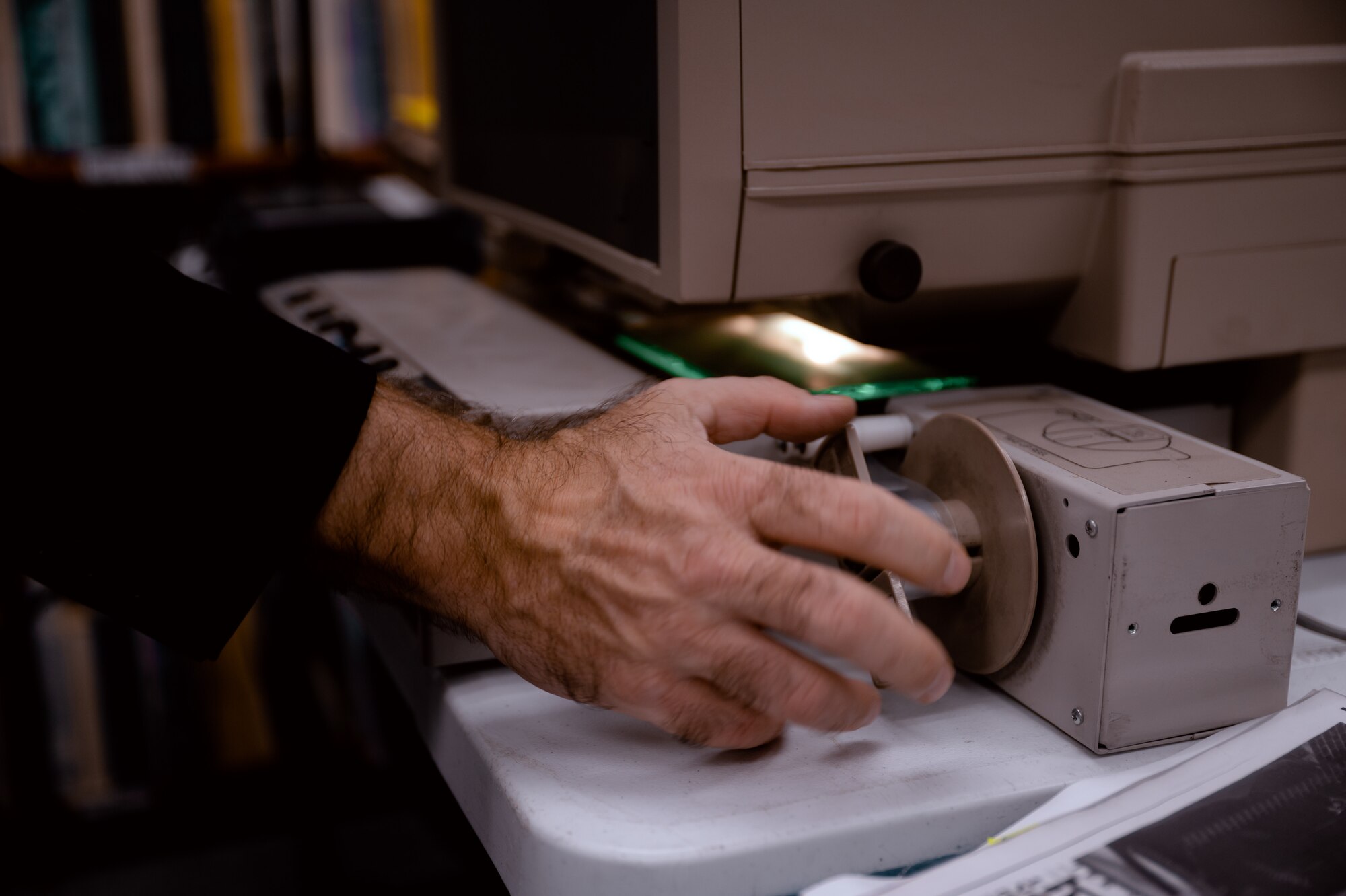 Robert Clark operates a microfilmer.