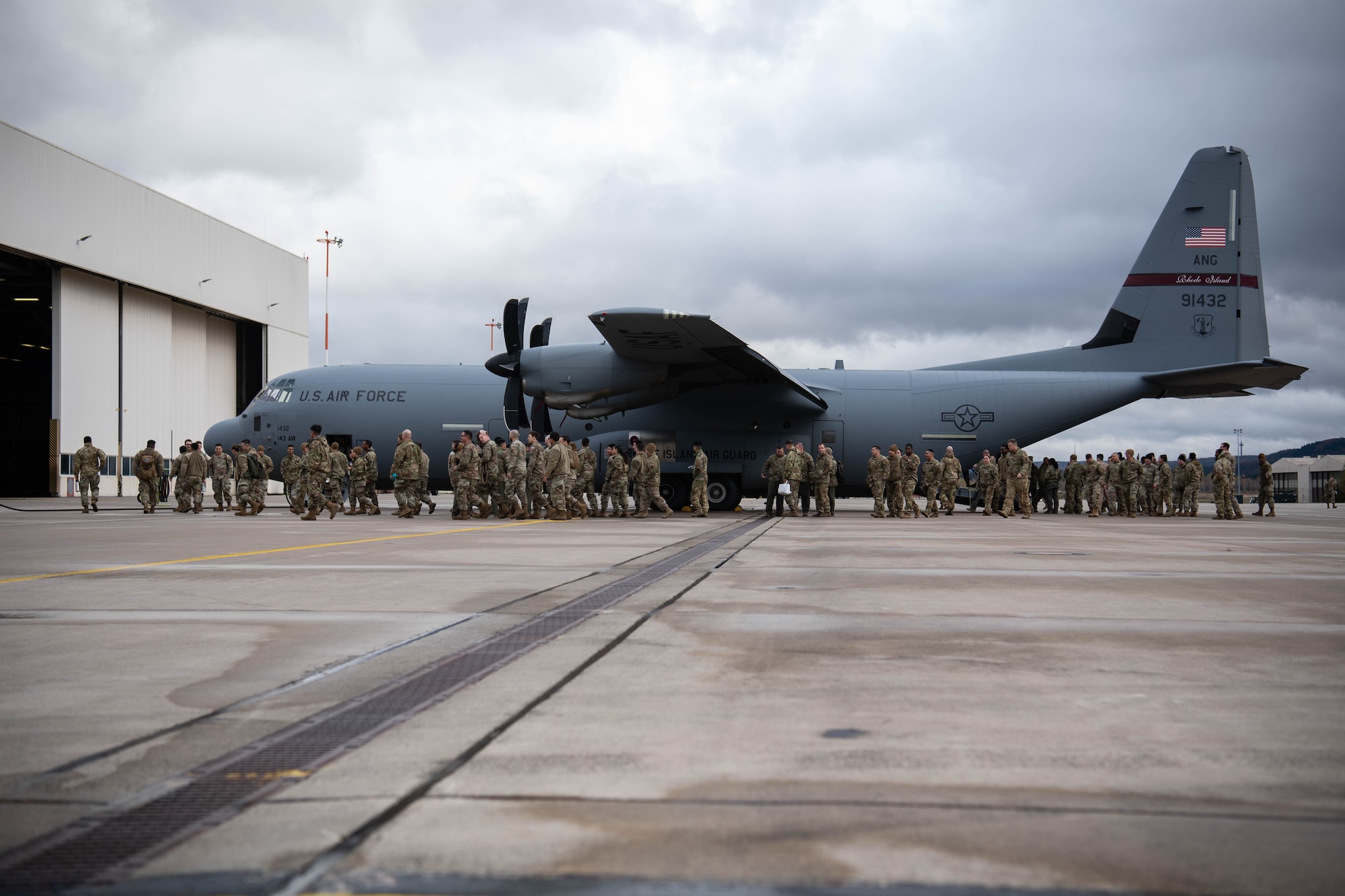 U.S. Air Force Airmen assigned to the 37th Airlift Squadron, as well as deployed Airmen assigned to the 621st Contingency Response Wing, Travis Air Force Base, California, and Quonset Point Air National Guard Station, Rhode Island, depart a C-130J Super Hercules aircraft after participating in floor-loading training at Ramstein Air Base, Germany, Nov. 9, 2023. The 37th AS held this training event to rehearse floor-loading procedures used primarily in contingency operations and humanitarian aid missions, during which the maximum number of passengers are loaded onto an aircraft without the standard use of seatbelts or stanchions. (U.S. Air Force photo by Senior Airman Jared Lovett)