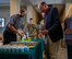 Members of Team Minot celebrate the ribbon-cutting ceremony for the opening of Myers Market at Minot Air Force Base, North Dakota, Nov. 15, 2023. Myers Market is located inside the Vosler Hall dormitory. During the event free samples of snacks that Myers Market provides were given to attendees during the ceremony. (U.S. Air Force photo by Airman 1st Class Luis Gomez)