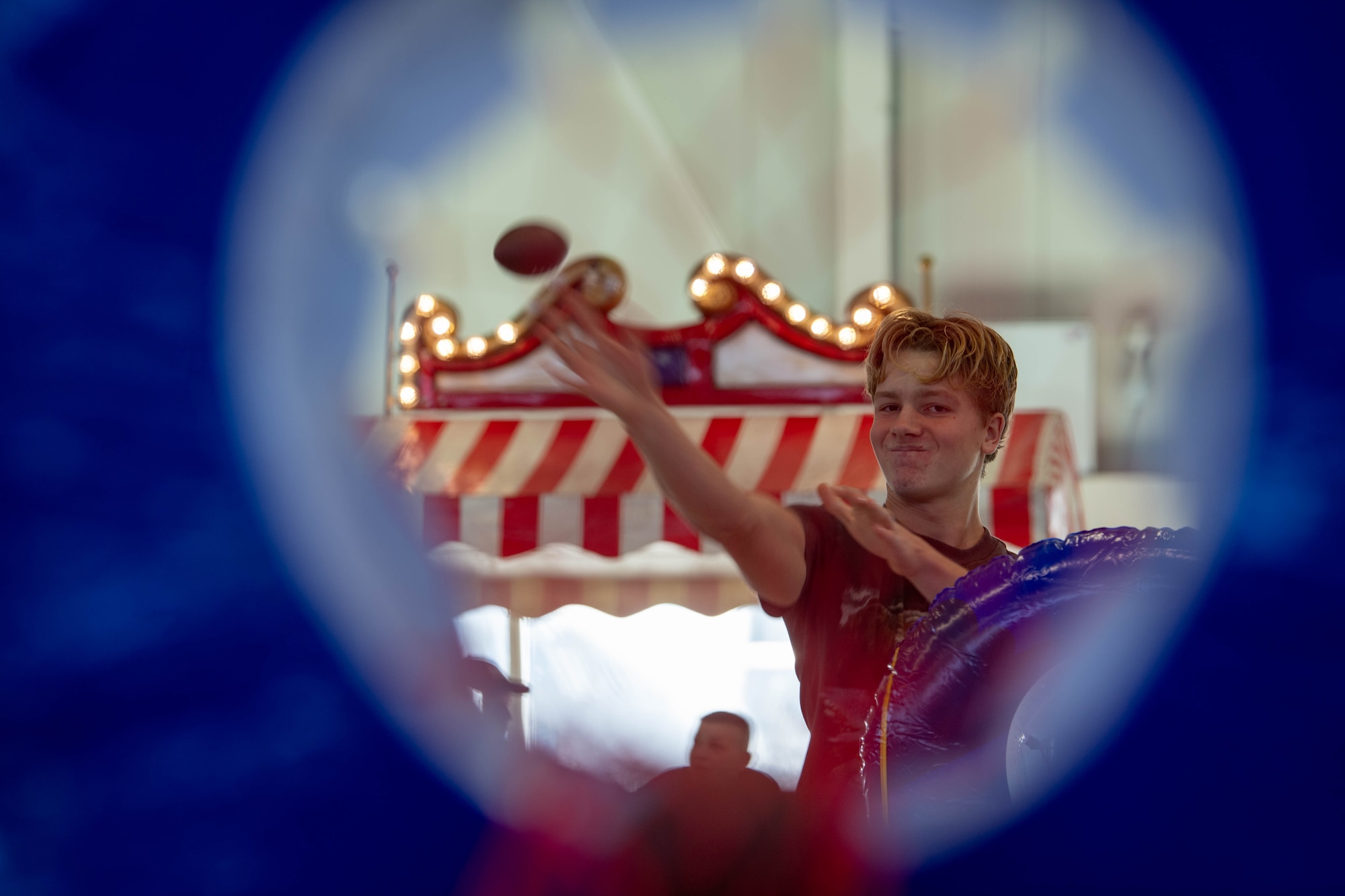 A Kaiserslautern Military Community member throws a football during a tailgate event at Ramstein Air Base, Germany, Nov. 11, 2023.