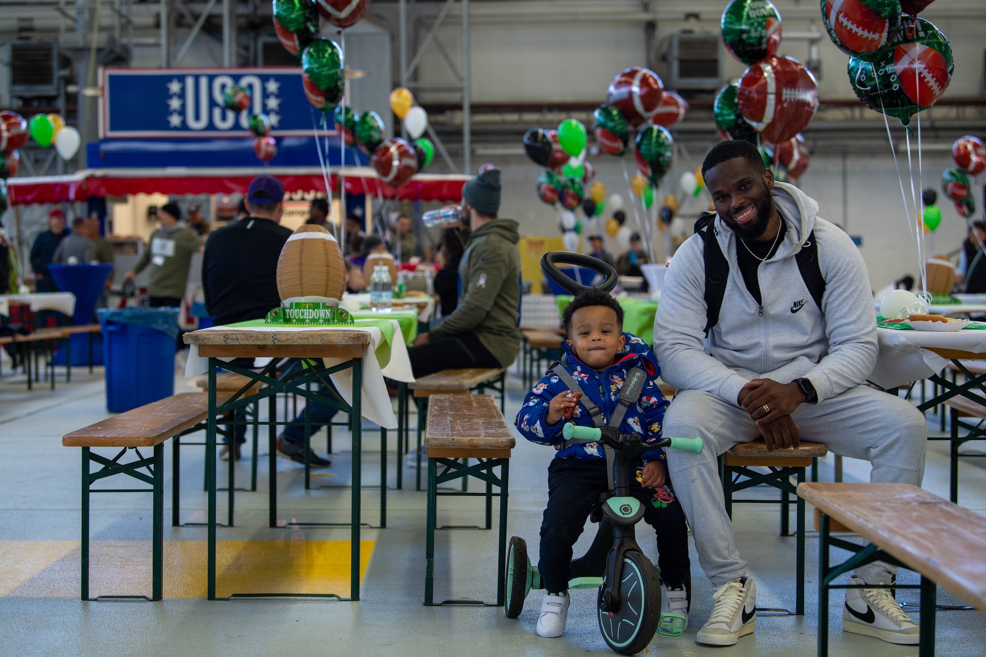 A father and son sit together during a tailgate event at Ramstein Air Base, Germany, Nov. 11, 2023.