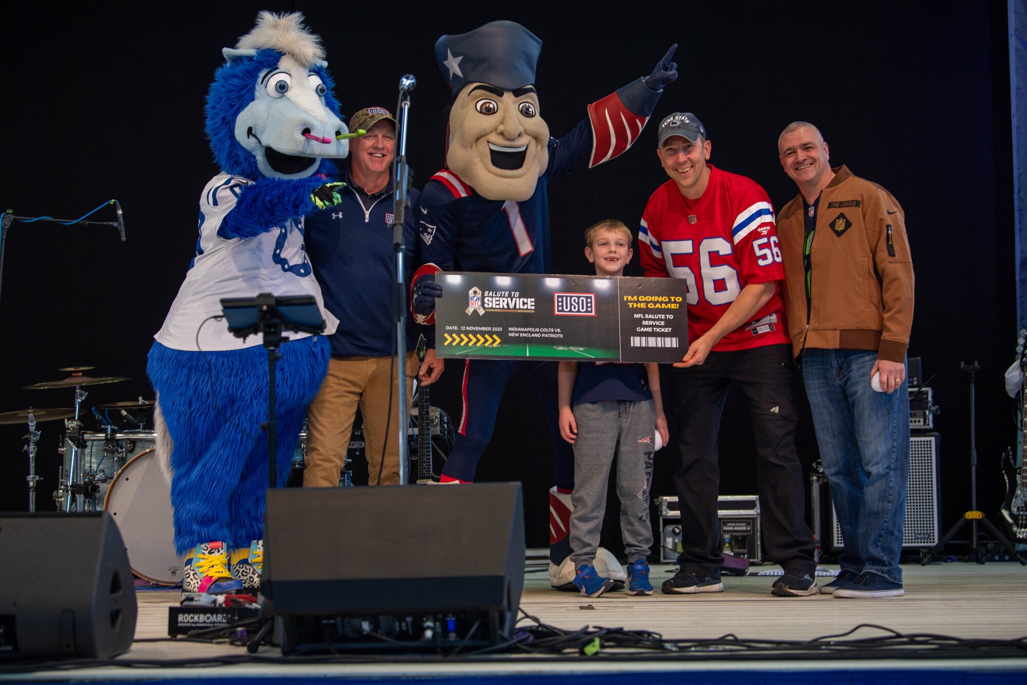 U.S. Air Force Col. James Cunningham, 86th Mission Support Group commander, presents National Football League tickets to raffle winners during a tailgate event at Ramstein Air Base, Germany, Nov. 11, 2023.
