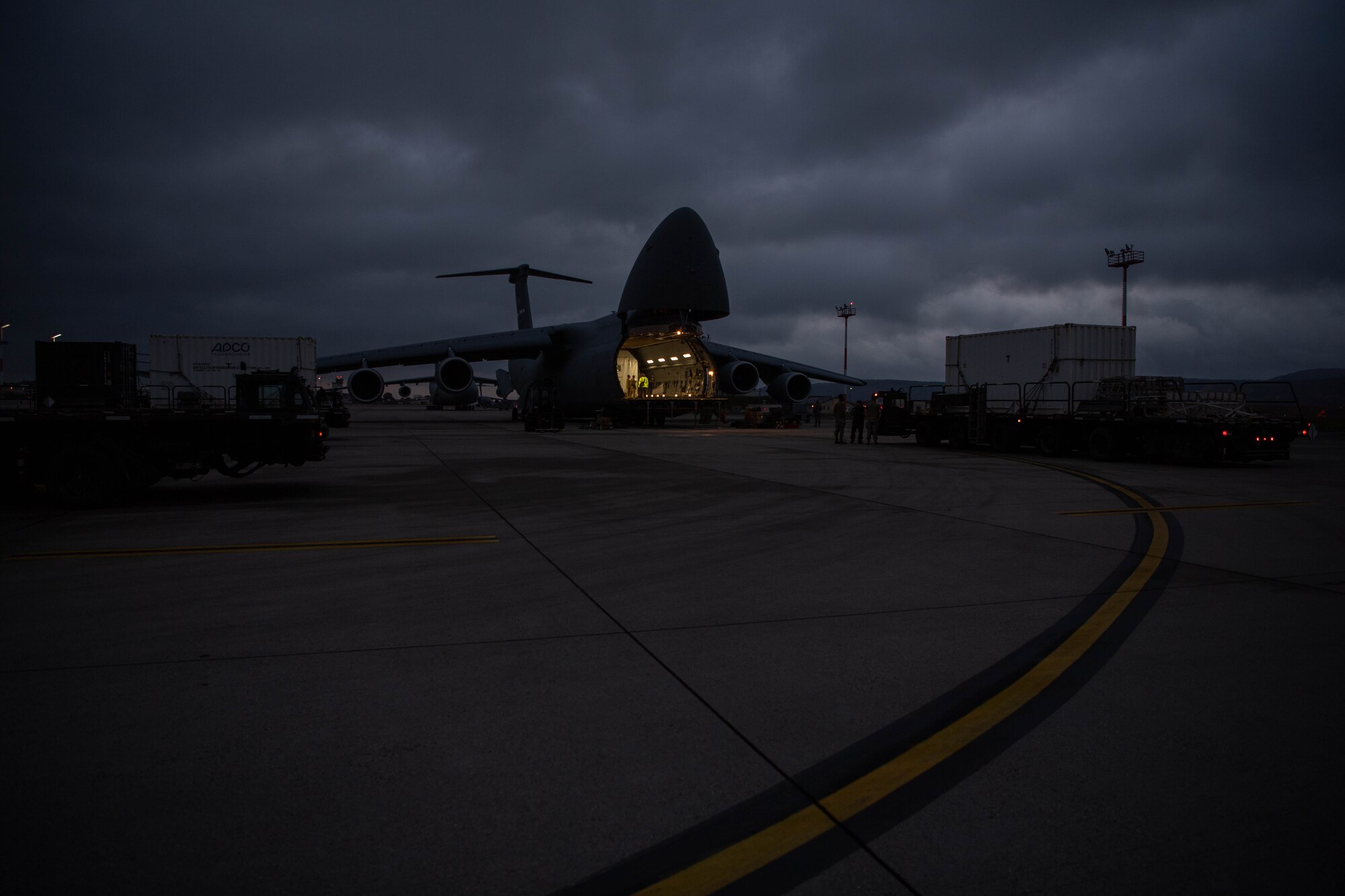 U.S. Air Force Airmen assigned to the 721st Aerial Port Squadron and Travis Air Force Base, California, load satellites onto a Lockheed C-5 Galaxy aircraft at Ramstein Air Base, Germany, Nov. 16, 2023.