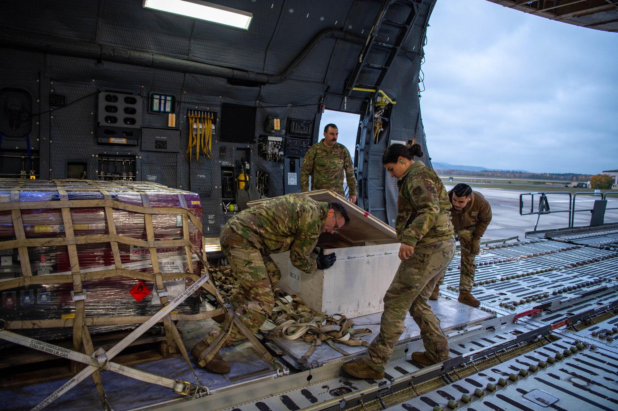 U.S. Air Force Airmen assigned to the 721st Aerial Port Squadron and Travis Air Force Base, California, load satellites onto a Lockheed C-5 Galaxy aircraft at Ramstein Air Base, Germany, Nov. 16, 2023.