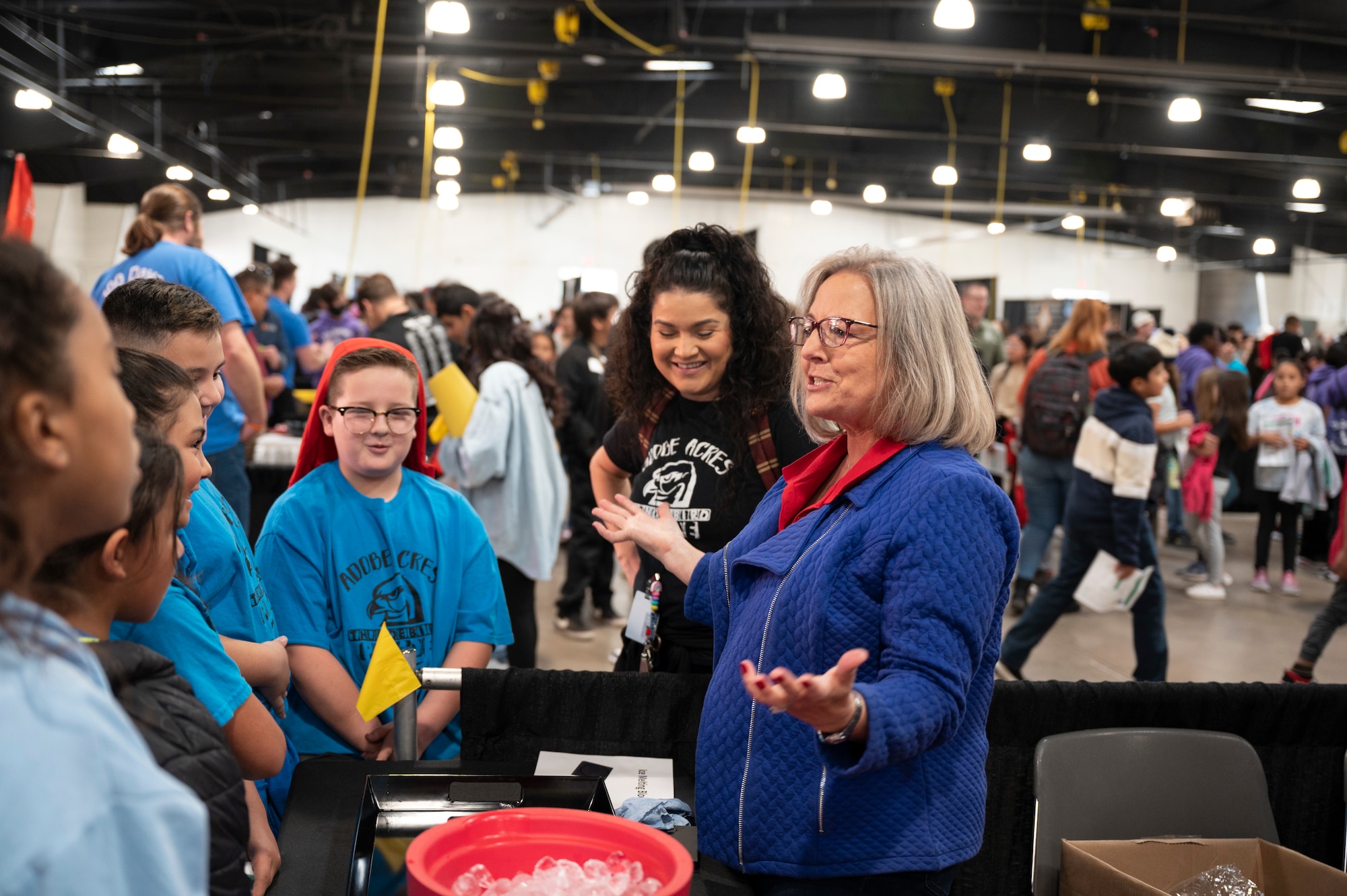 A woman speaks to students.