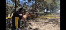 Man in Army Polo shooting a rifle