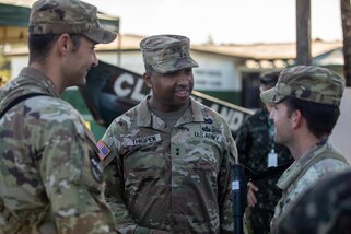 Three Soldiers talk after the closing ceremony for Exercise Southern Vanguard 24 in Oiapoque, Brazil.