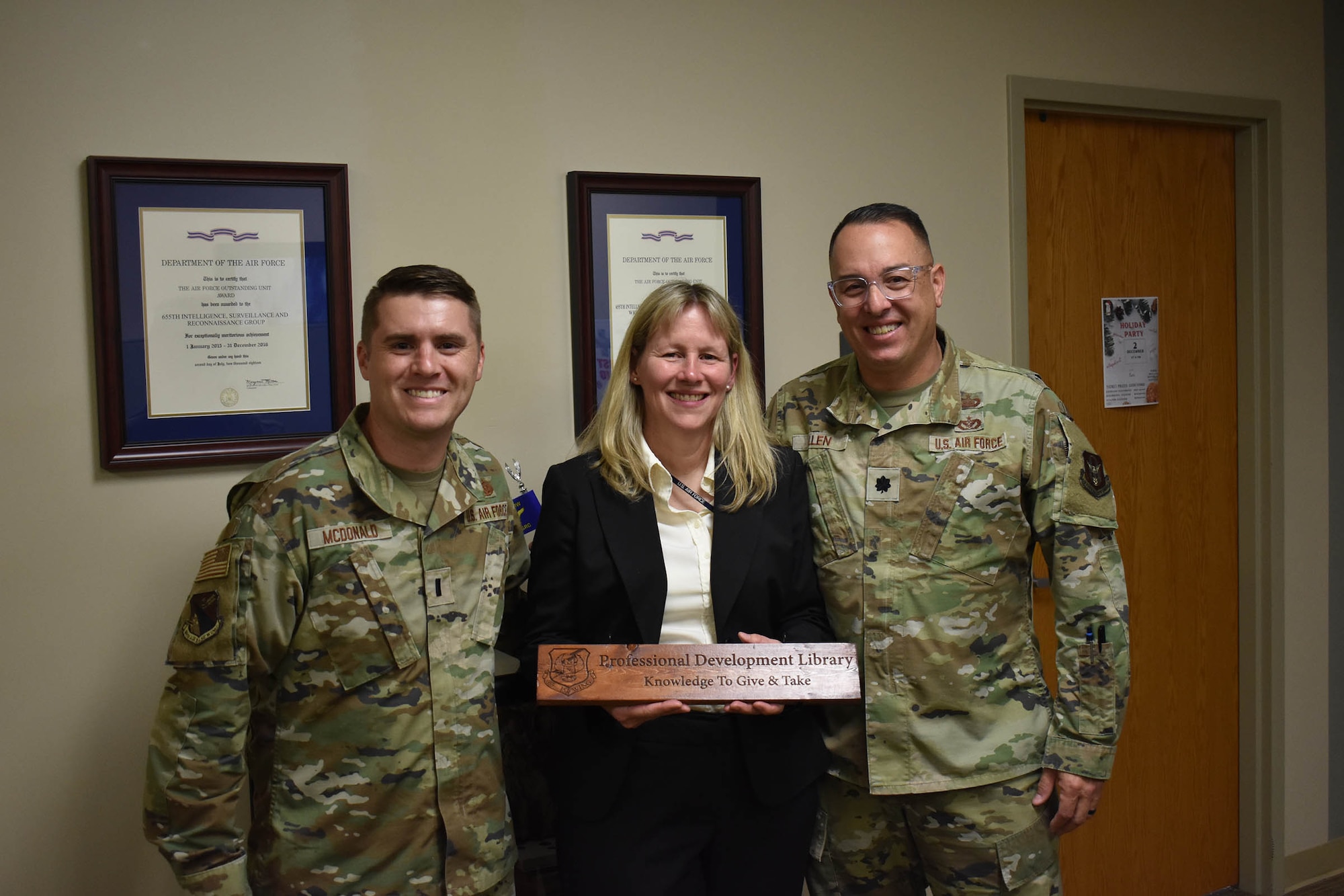 From left, 1st Lt. Matt McDonald, retired Lt. Col. Audrey Swinney and Lt. Col. Brent Allen – some of the original 655th Intelligence, Surveillance and Reconnaissance (ISR) Group members when the group stood up in 2013 – were honored as 655th ISRG “Plank Holders” on Nov. 3, 2023, at the 655th ISR Wing headquarters. The group named 16 members as plank holders when the group officially stood up in September 2013.