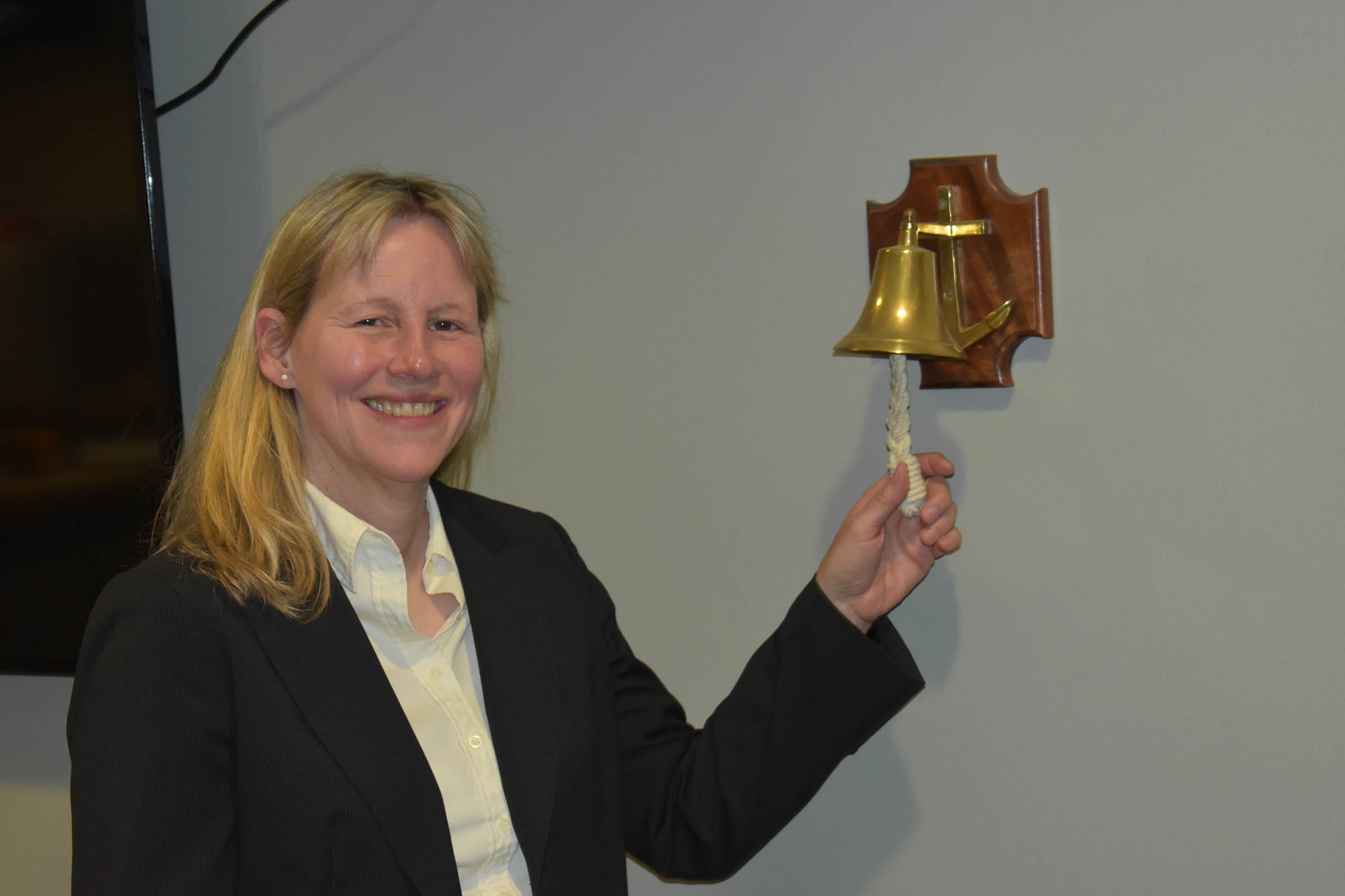 Retired Lt. Col. Audrey Swinney, National Air and Space Intelligence Center customer engagement and protocol and an original member of the 655th Intelligence, Surveillance and Reconnaissance (ISR) Group when it stood up in 2013, rings the bell that signals of the departure of a “Plank Holder.” She along with two of the original 16 655th ISRG plank holders were honored with planks on Nov. 3, 2023, at the 655th ISR Wing headquarters.