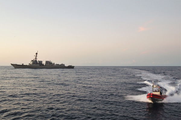 U.S. Coast Guard Cutter Vigilant (WMEC-617) conducts a joint operation with the USS Farragut (DDG-99) to interdict a drug smuggling vessel, Oct. 15, 2023