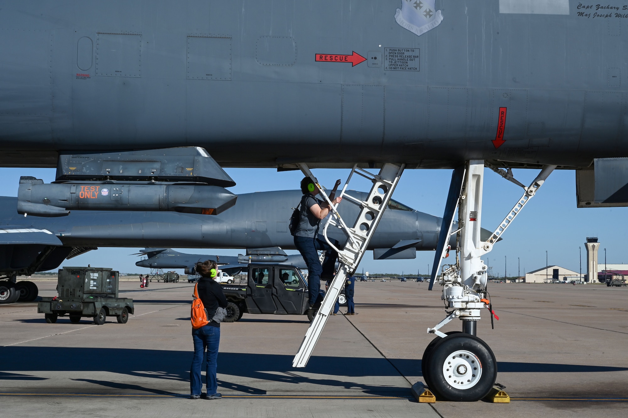 Courtney Stankavich and Dr. Angela Thays, METSS Corporation researchers and Next Generation Aircrew Protection team members, enter a B-1B Lancer to turn on vapor purge testing sensors on Dyess Air Force Base, Texas, Nov. 7, 2023. Using the information gathered from the vapor purge test done on the B-1, the team will create data sets showcasing vapor concentrations at different times during flight. (U.S. Air Force photo by Senior Airman Sophia Robello)
