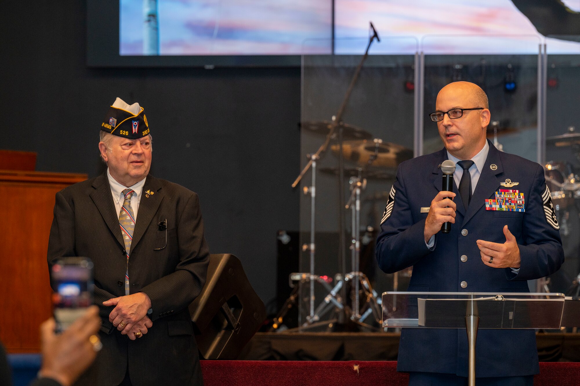 Air Force Life Cycle Management Center Command Chief James Fitch, right, provides remarks during a Veterans Day ceremony at the United Methodist Church in Fairborn, Ohio, Nov. 11, 2023. Fitch joined the Air Force in 1995 and spoke about his time in service. (U.S. Air Force photo by Staff Sgt. Mikaley Kline)