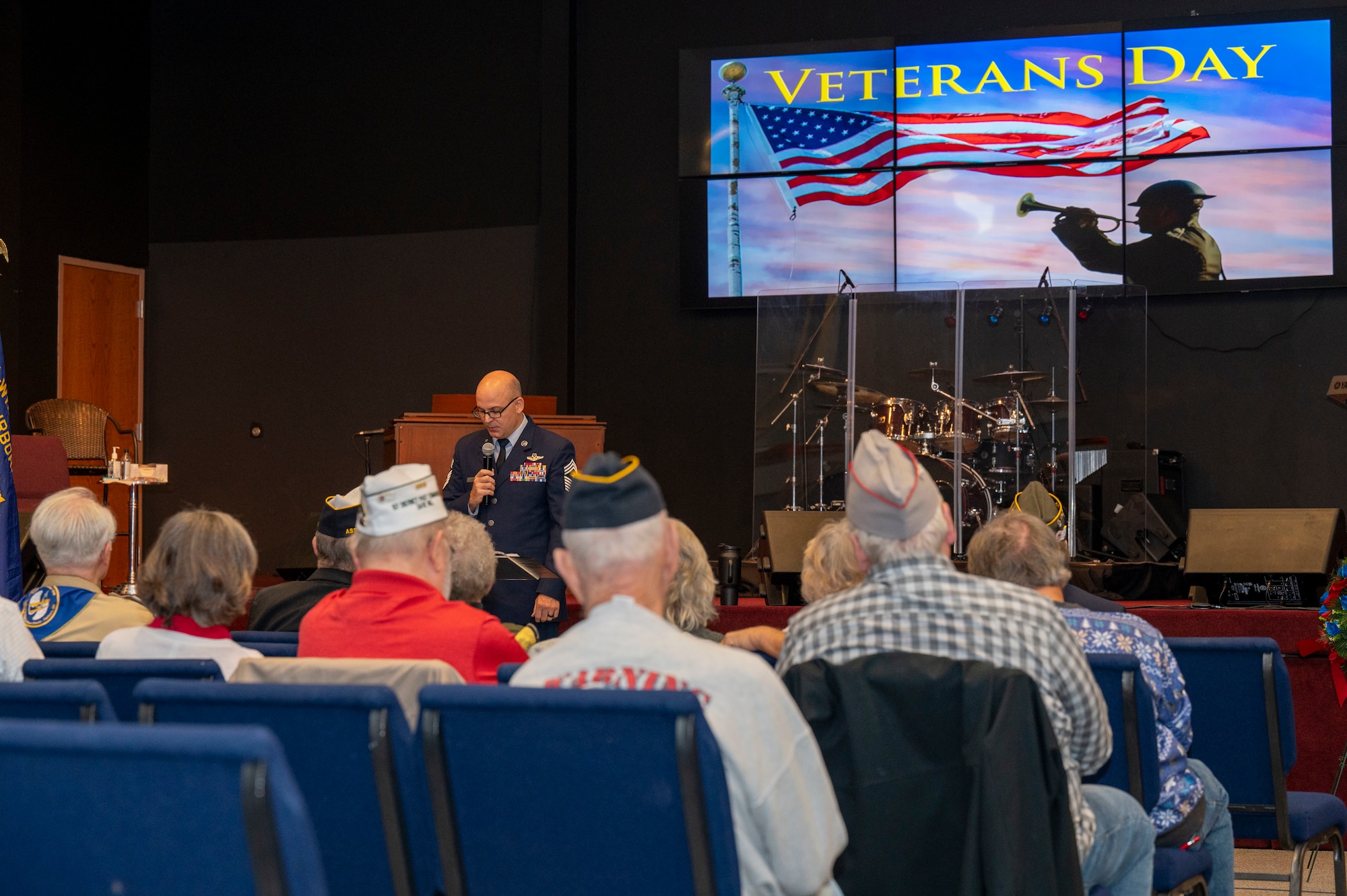 Air Force Life Cycle Management Center Command Chief James Fitch, right, provides remarks during a Veterans Day ceremony at the United Methodist Church in Fairborn, Ohio, Nov. 11, 2023. Fitch spoke about his time in service and honored two of his daughters who also serve in the Air Force. (U.S. Air Force photo by Staff Sgt. Mikaley Kline)