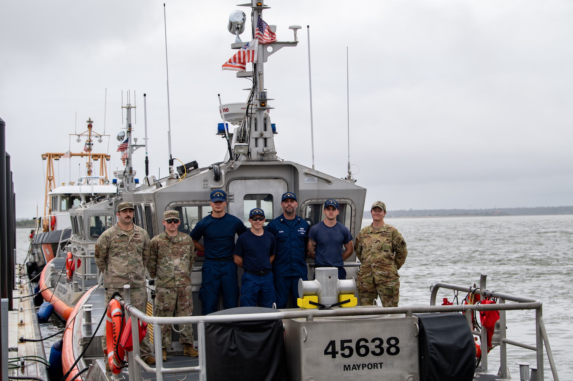 U.S. Air Force Airmen assigned to the 347th Operations Support Squadron smile with U.S. Coast Guardsmen from Coast Guard Station Mayport during a joint team exercise off the coast of Jacksonville on Nov. 17, 2023. The two branches came together for an extended day of joint team training during exercise Mosaic Tiger 24-1. (U.S. Air Force photo by Senior Airman Courtney Sebastianelli)