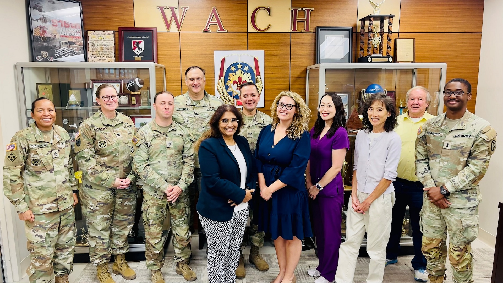 Senior leadership and laboratory staff pose for a picture with College of American Pathologists inspection staff.