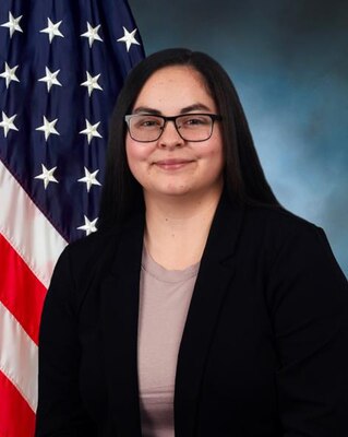 McKenzie Brinkerhoff official photo with American and DLA flag in background